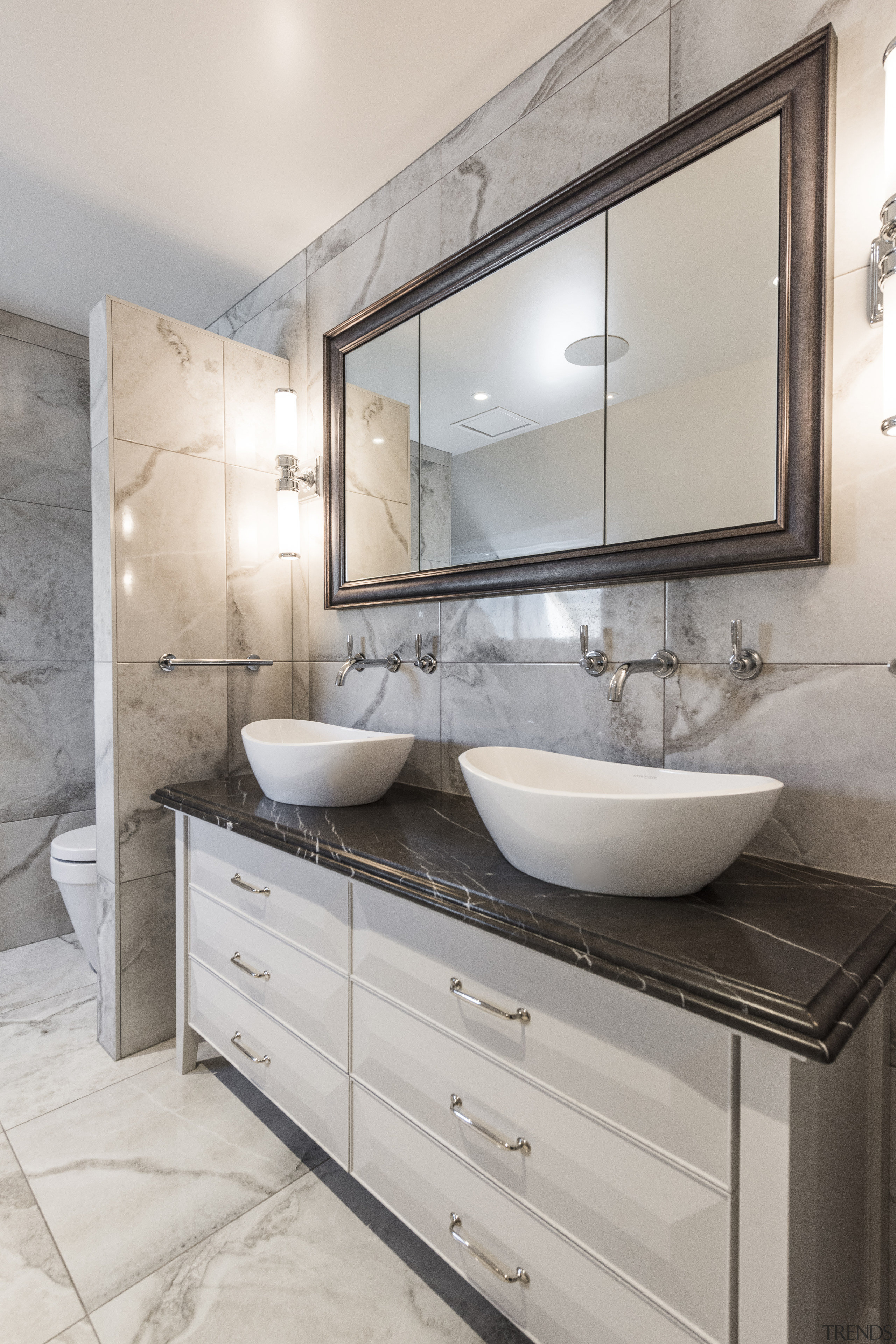 The natural stone vanity top provides a stunning architecture, bathroom, bathroom accessory, bathroom cabinet, building, cabinetry, ceiling, countertop, floor, flooring, furniture, home, house, interior design, marble, material property, plumbing fixture, property, real estate, room, sink, tap, tile, wall, gray