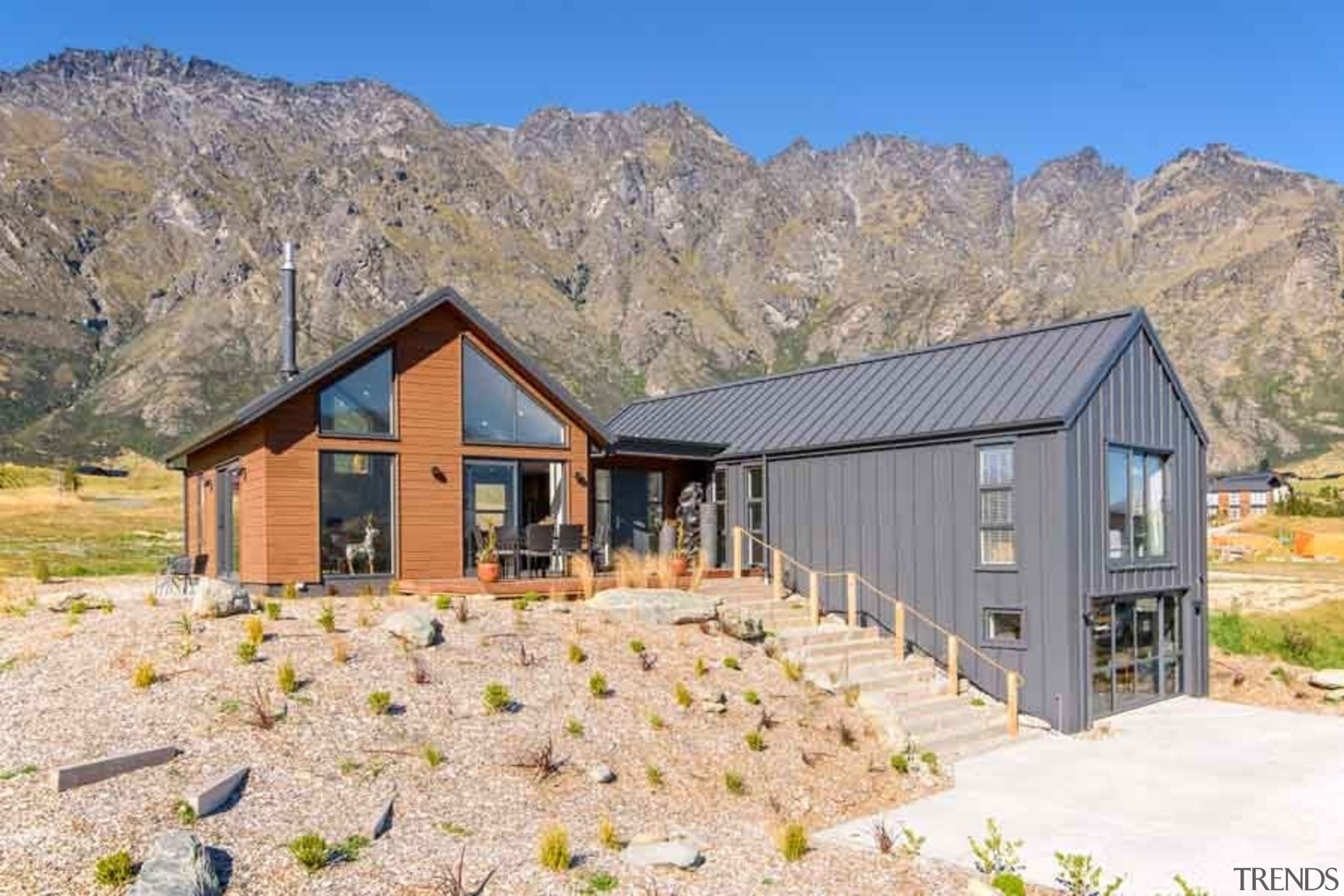 Easy family living is hte priority for this cottage, elevation, farmhouse, home, house, hut, landscape, log cabin, mountain, property, real estate, shed, gray, white