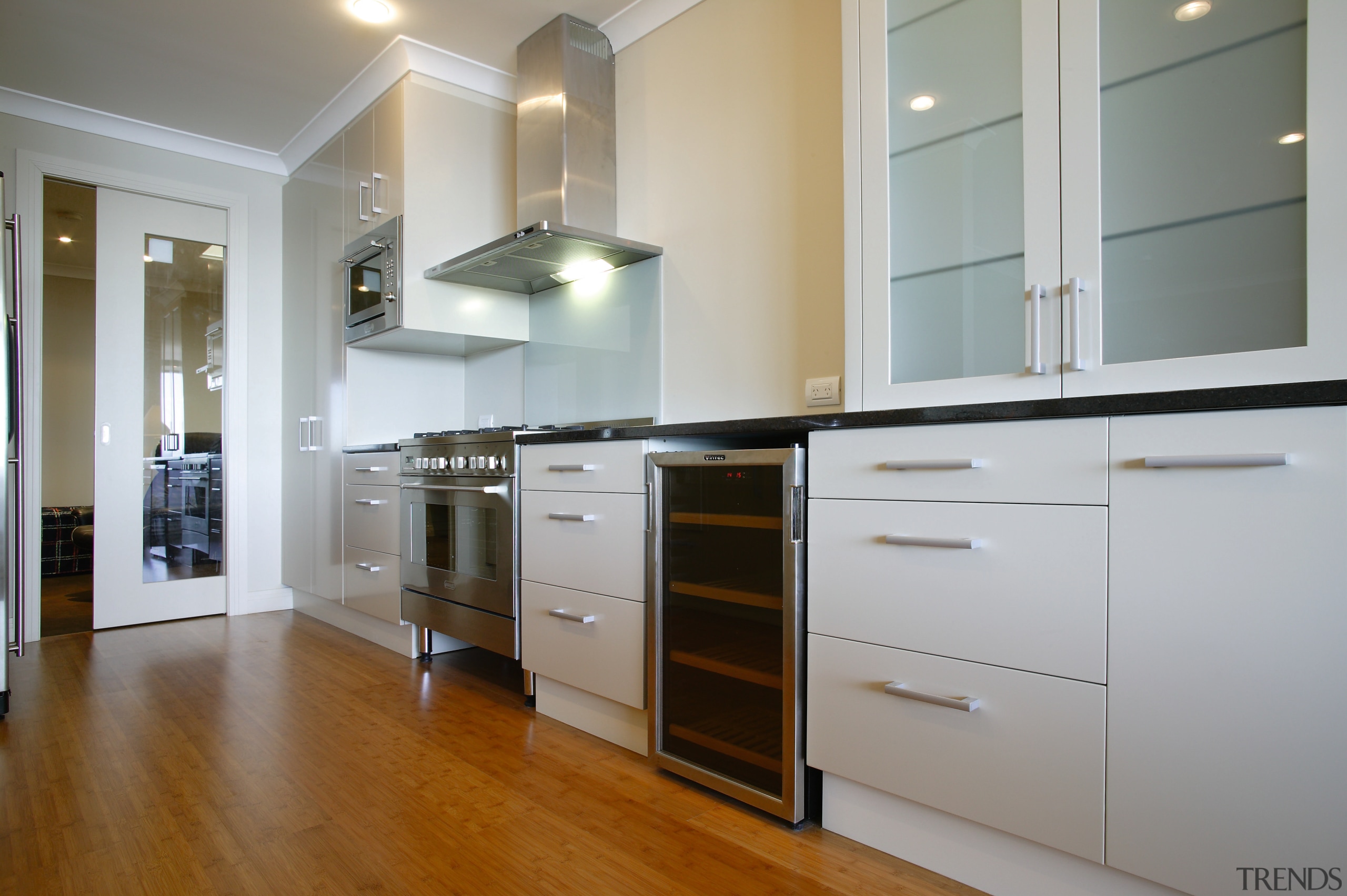 A view of the kitchen featuring solid bamboo cabinetry, countertop, cuisine classique, floor, flooring, hardwood, interior design, kitchen, room, wood flooring, gray