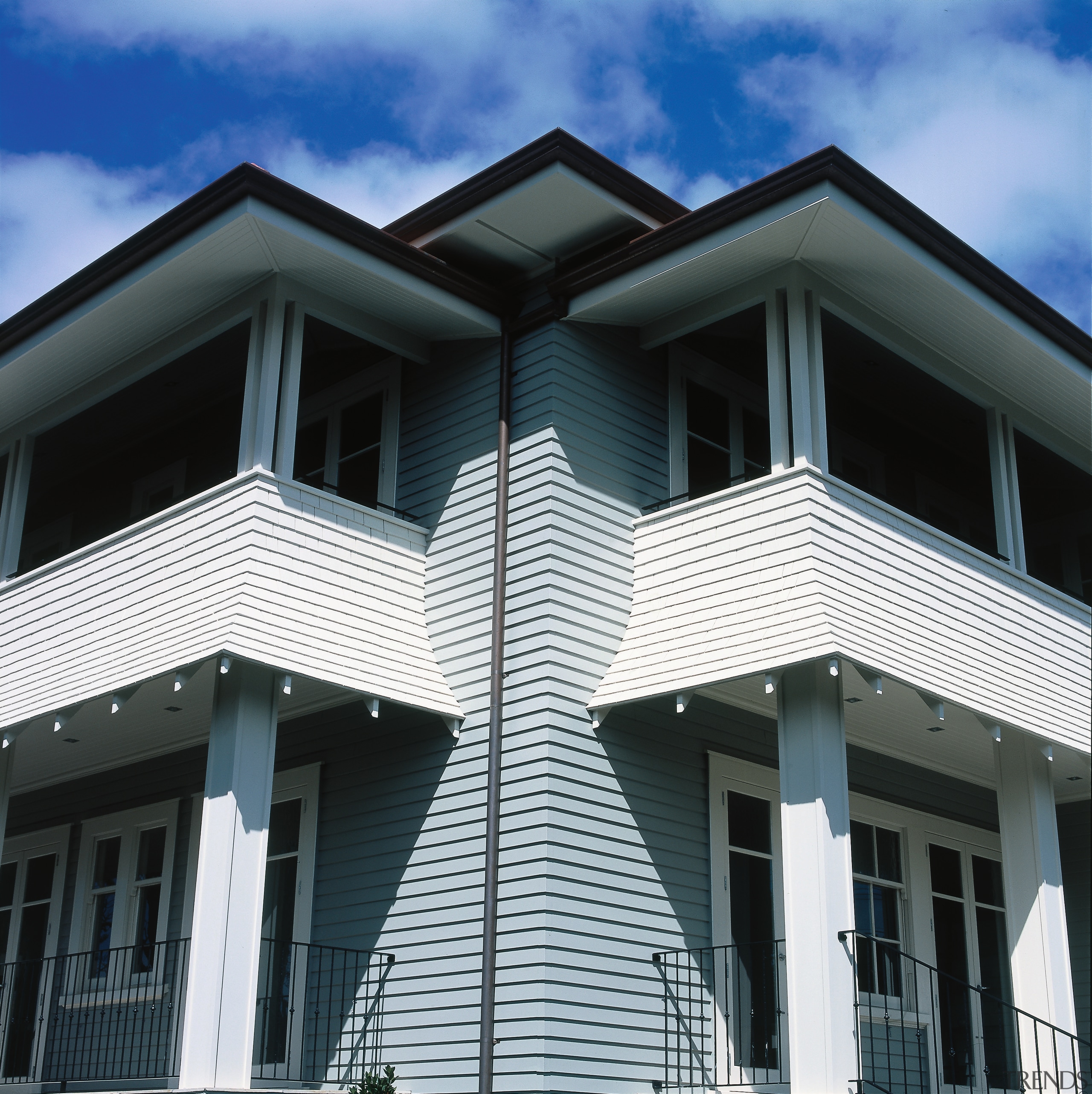 Two storey weatherboard house with balconies and columns. architecture, building, commercial building, elevation, facade, home, house, property, real estate, residential area, roof, siding, window, black