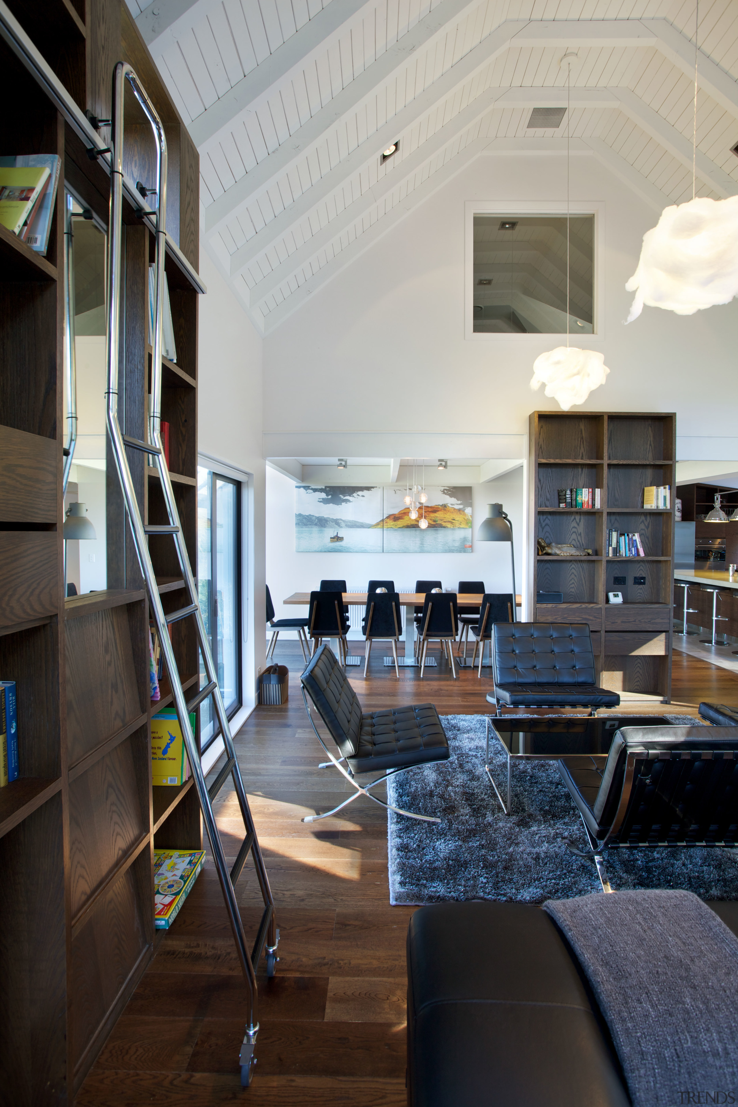 A storage wall and library-style access ladder were interior design, lobby, gray, black