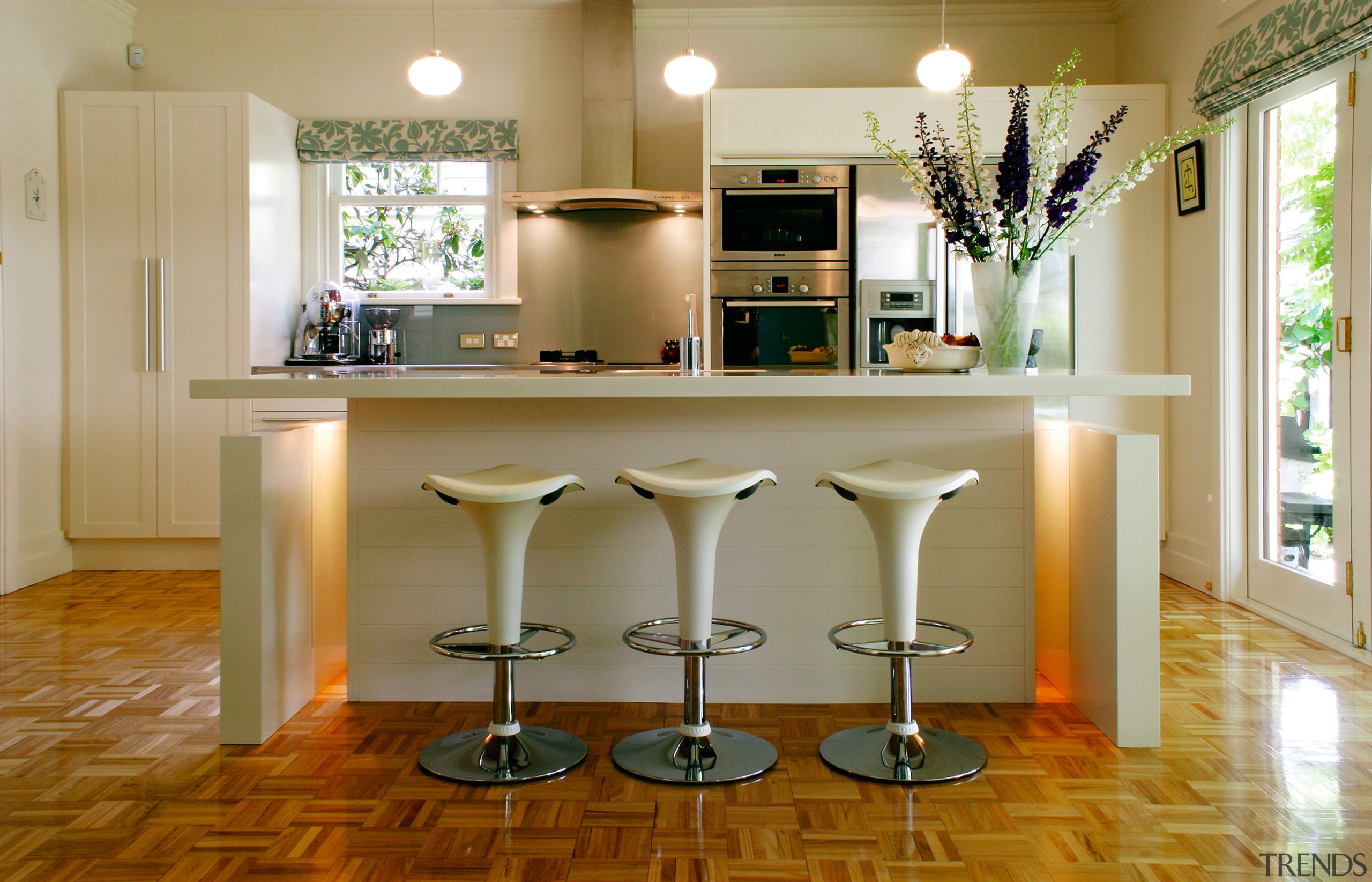A view of a kitchen by Simply Kitchens. cabinetry, countertop, cuisine classique, dining room, floor, flooring, furniture, hardwood, home, interior design, kitchen, laminate flooring, room, table, wood, wood flooring, brown
