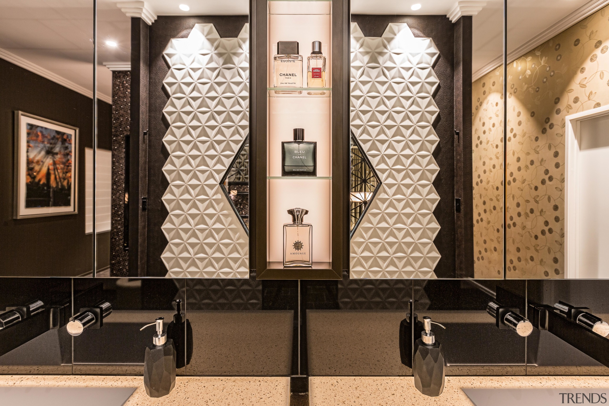 ​​​​​​​The mirror-fronted cabinet mirrors above the vanity reflect black