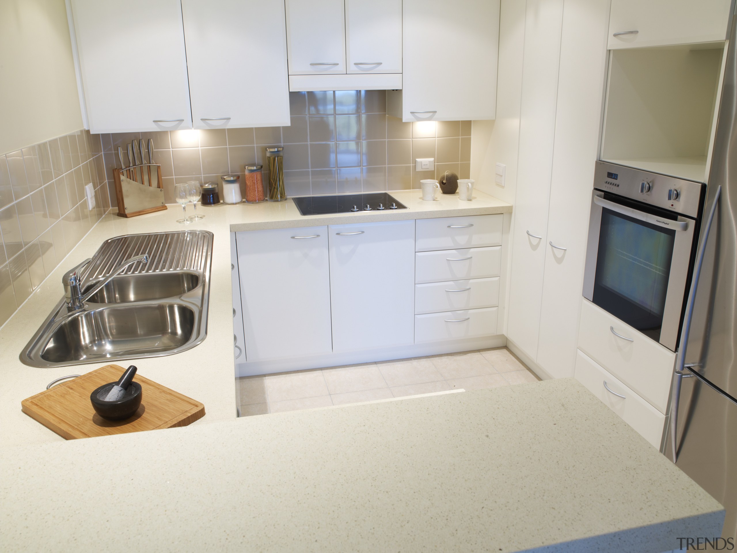 View of the kitchen of a unit at countertop, floor, kitchen, property, real estate, room, sink, white