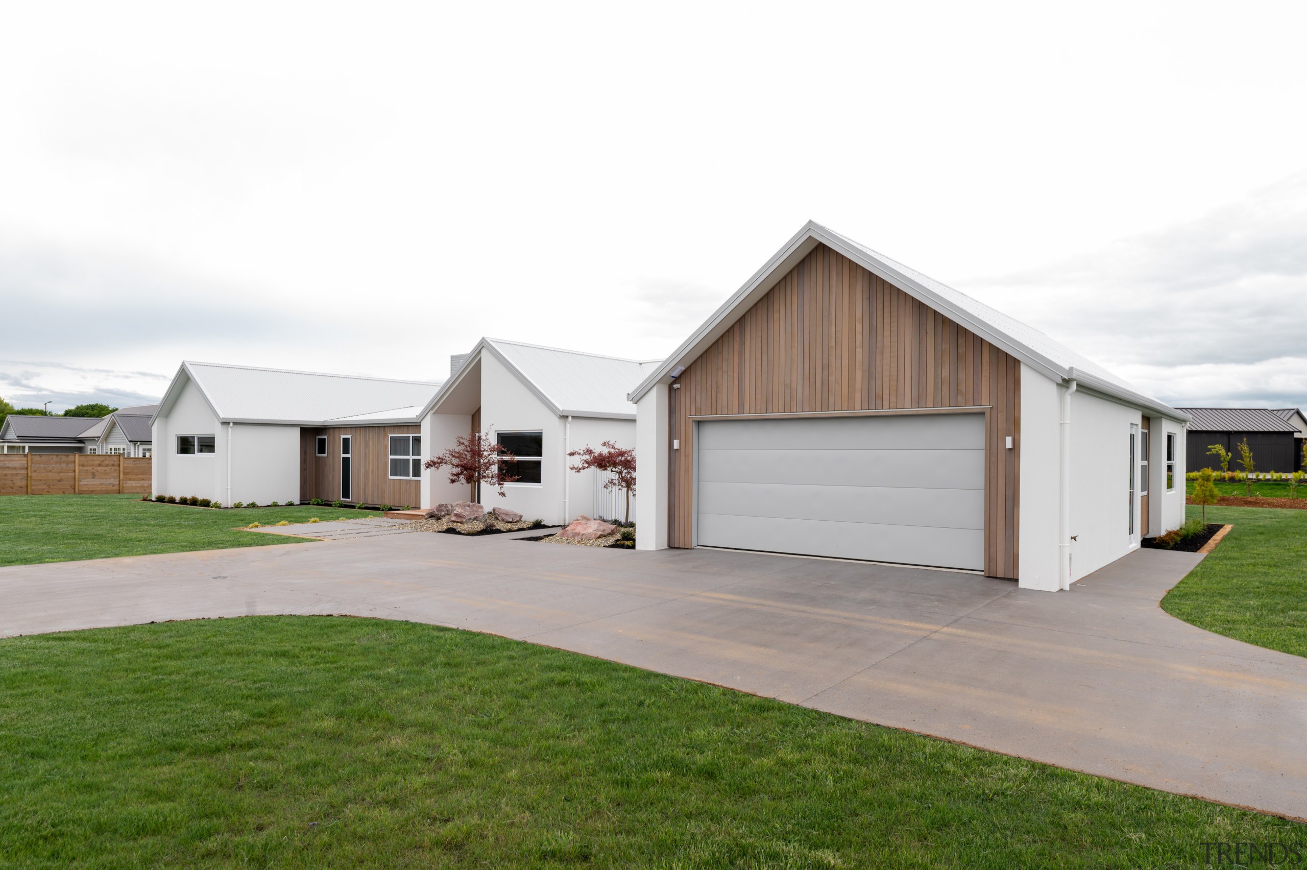 The double garage is faced in western red 