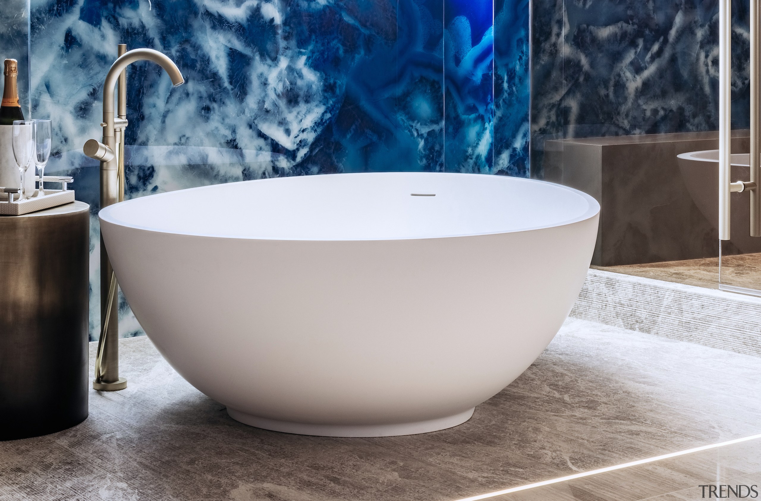 The egg-shaped tub anchors the wet area space, 
