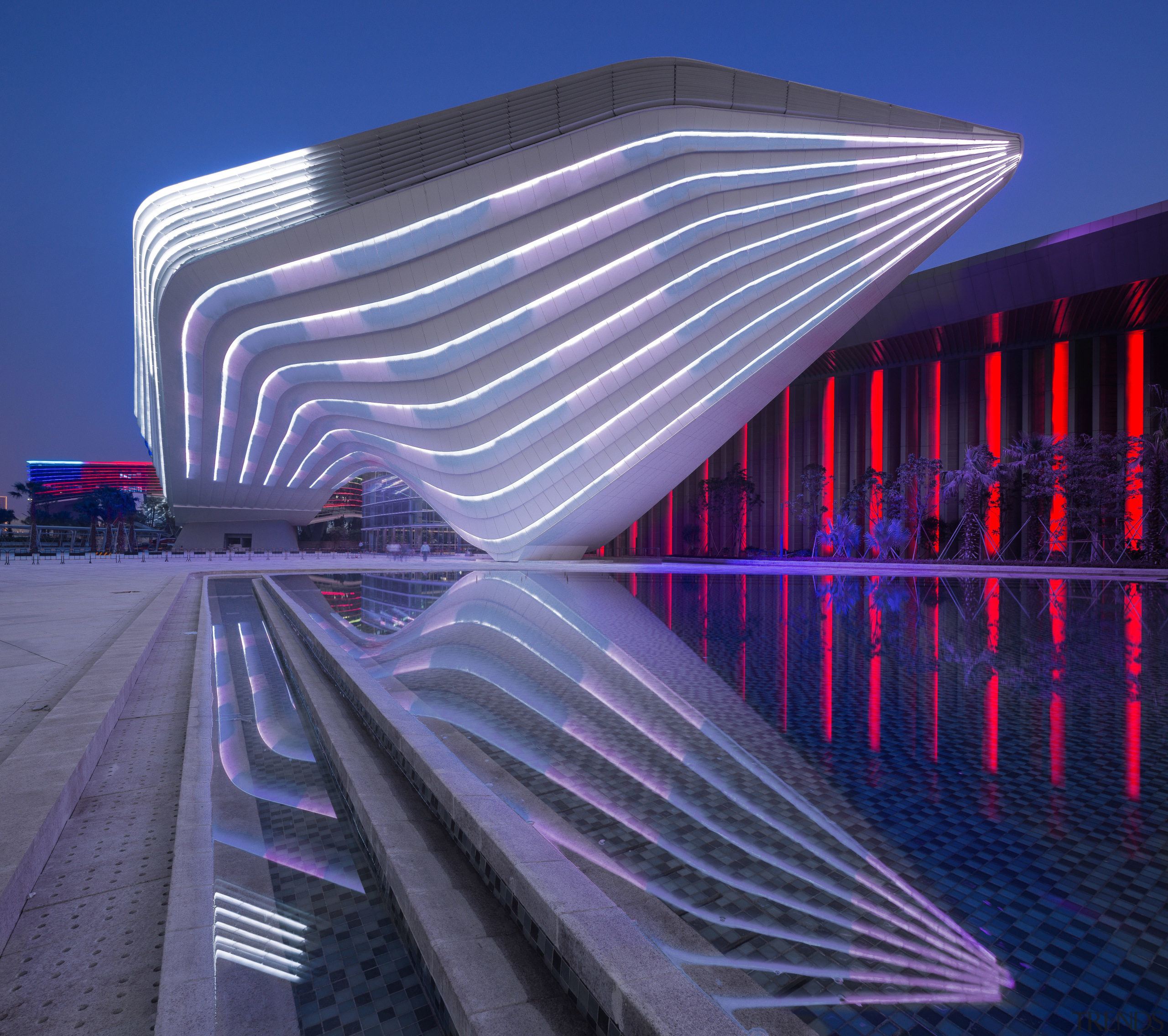 An architectural ribbon winds around the Zhuhai International architecture, building, corporate headquarters, daylighting, facade, landmark, light, lighting, line, metropolis, metropolitan area, purple, reflection, sky, skyscraper, structure, blue, purple