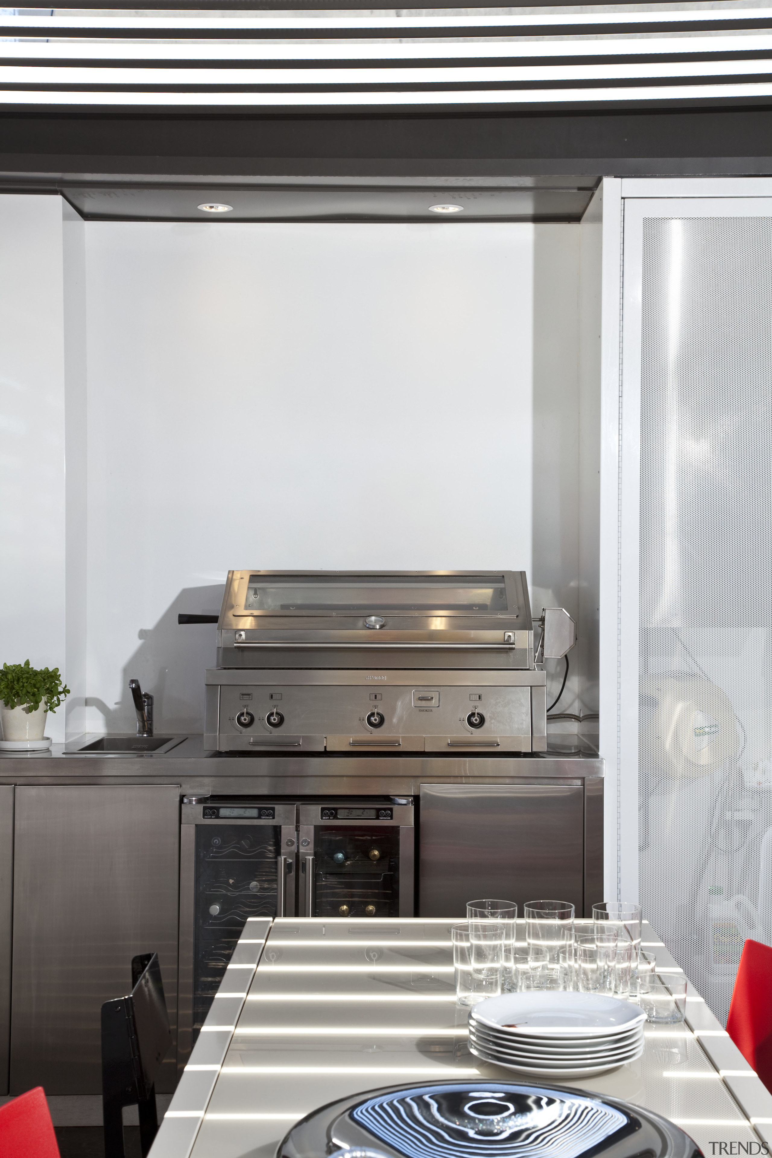 View of an outdoor kitchen which features a furniture, home appliance, interior design, kitchen, kitchen appliance, kitchen stove, white