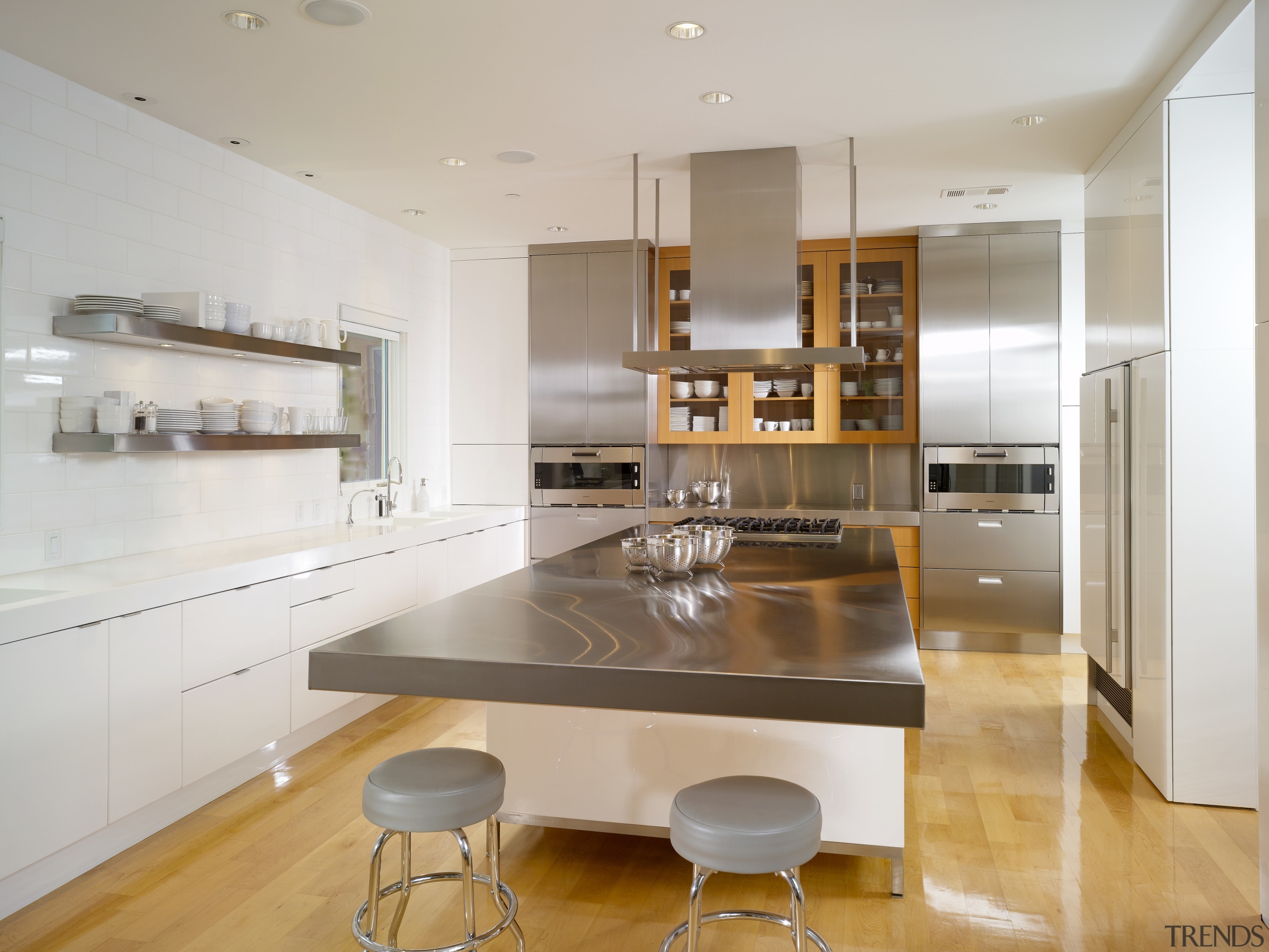 View of a condominium kitchen which features a cabinetry, countertop, cuisine classique, interior design, interior designer, kitchen, real estate, room, gray