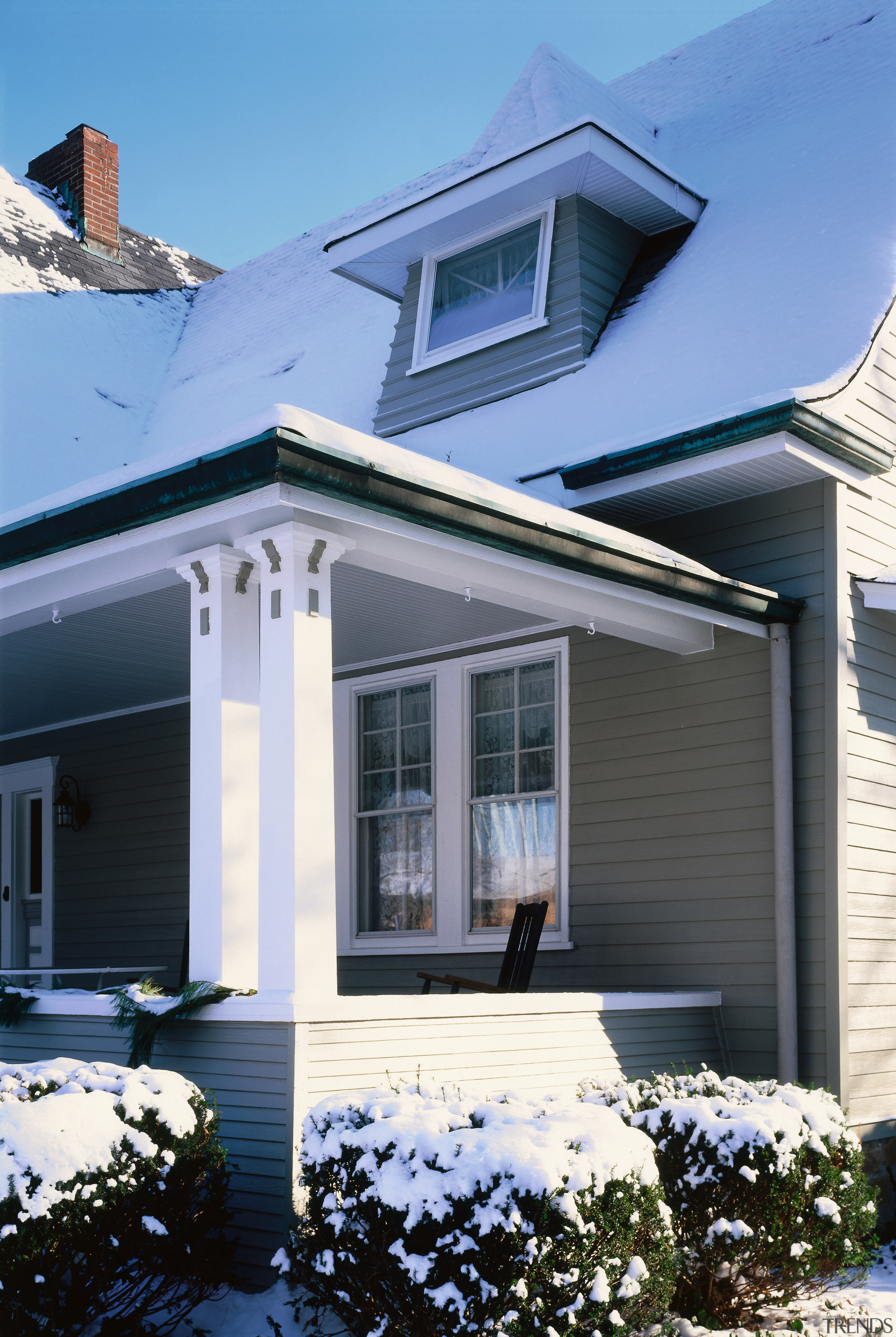 the witches hat dormar window  features a building, cottage, elevation, facade, home, house, porch, property, real estate, residential area, roof, siding, snow, window, winter, teal, black