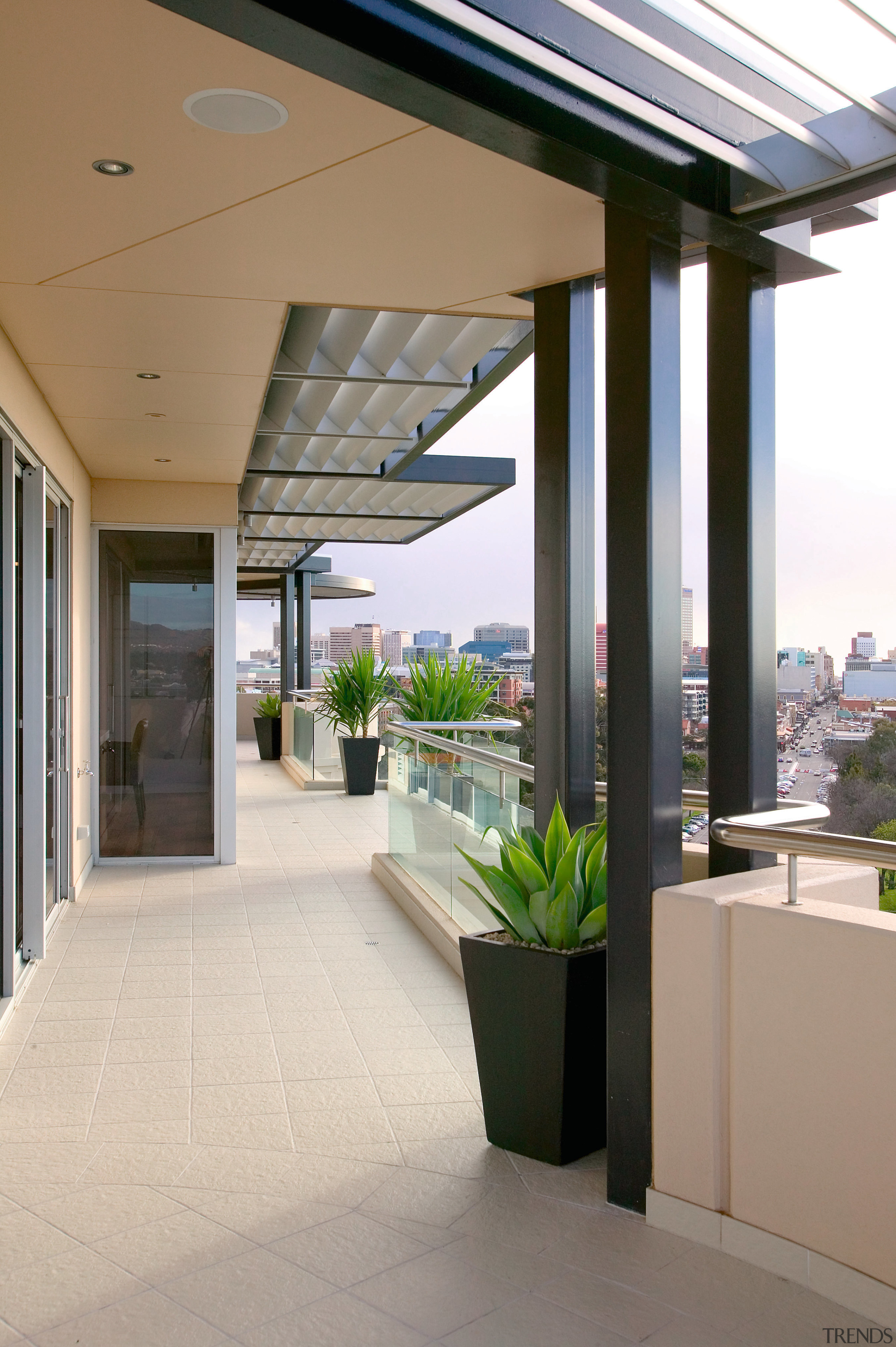 Wrap-around balcony of apartment with paving, glass balustrades, daylighting, floor, interior design, real estate, window, white