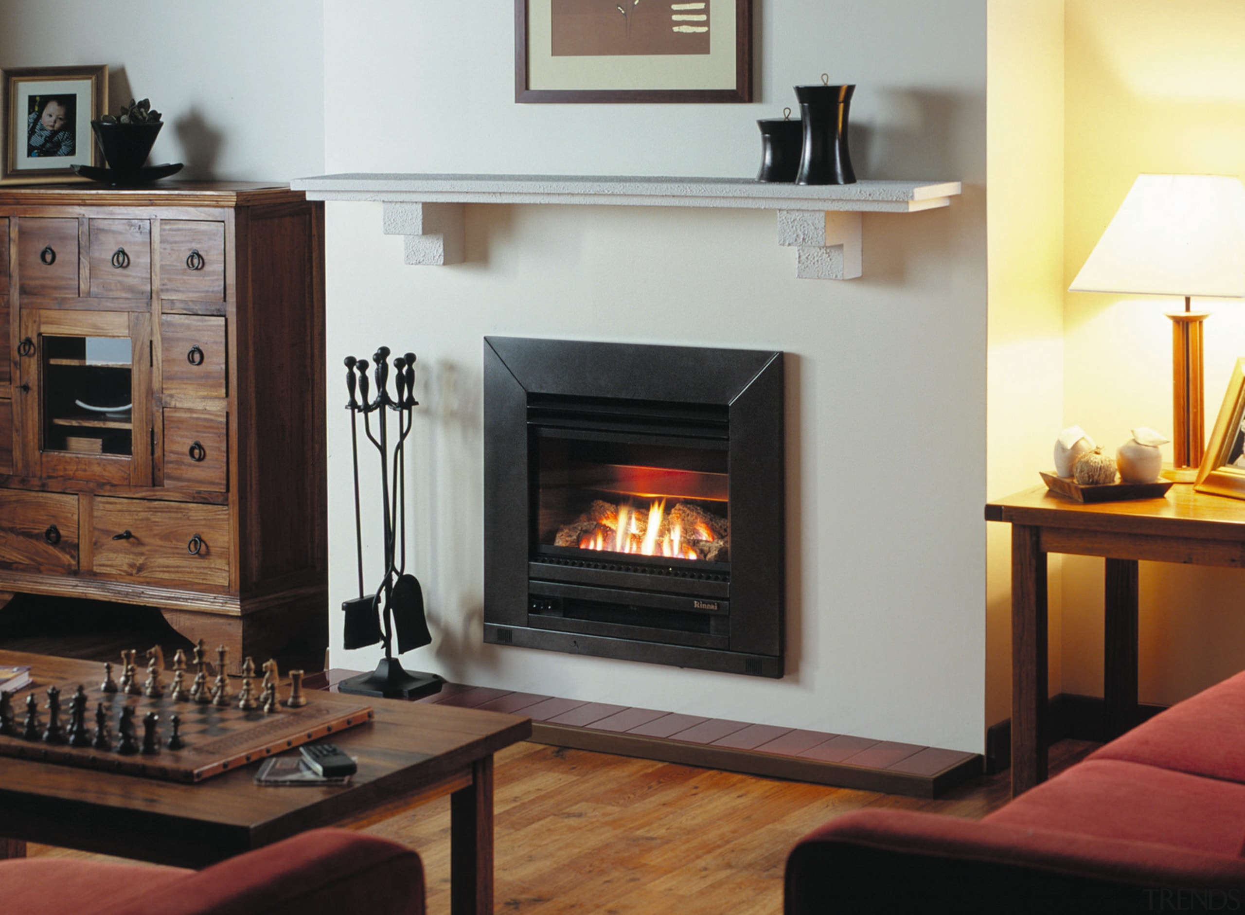 Lounge room with black firebox set into cream fireplace, hearth, heat, home appliance, wood burning stove, black