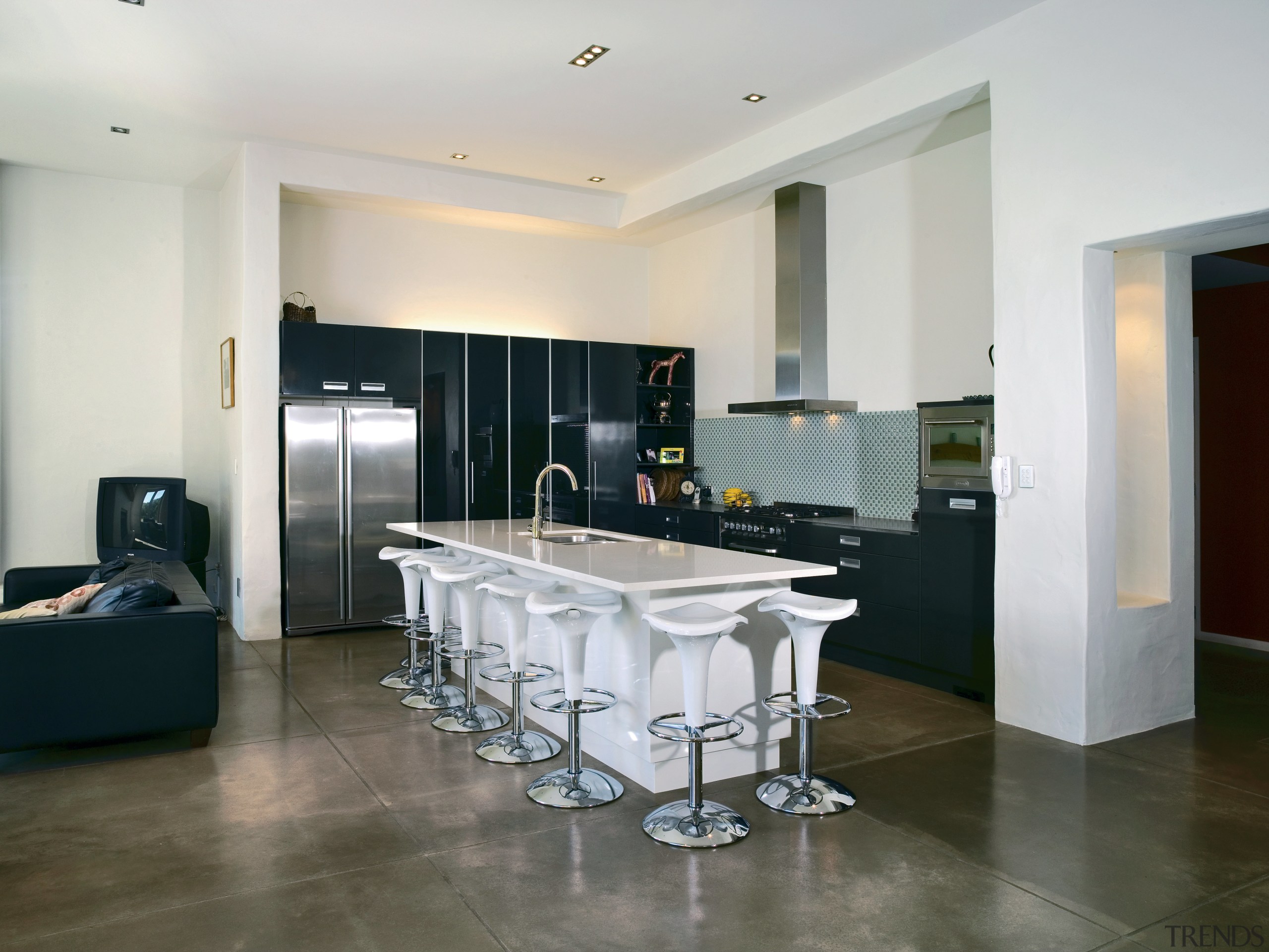 Open plan kitchen with black cabinetry and white ceiling, countertop, floor, flooring, interior design, kitchen, real estate, room, tile, wood flooring, gray