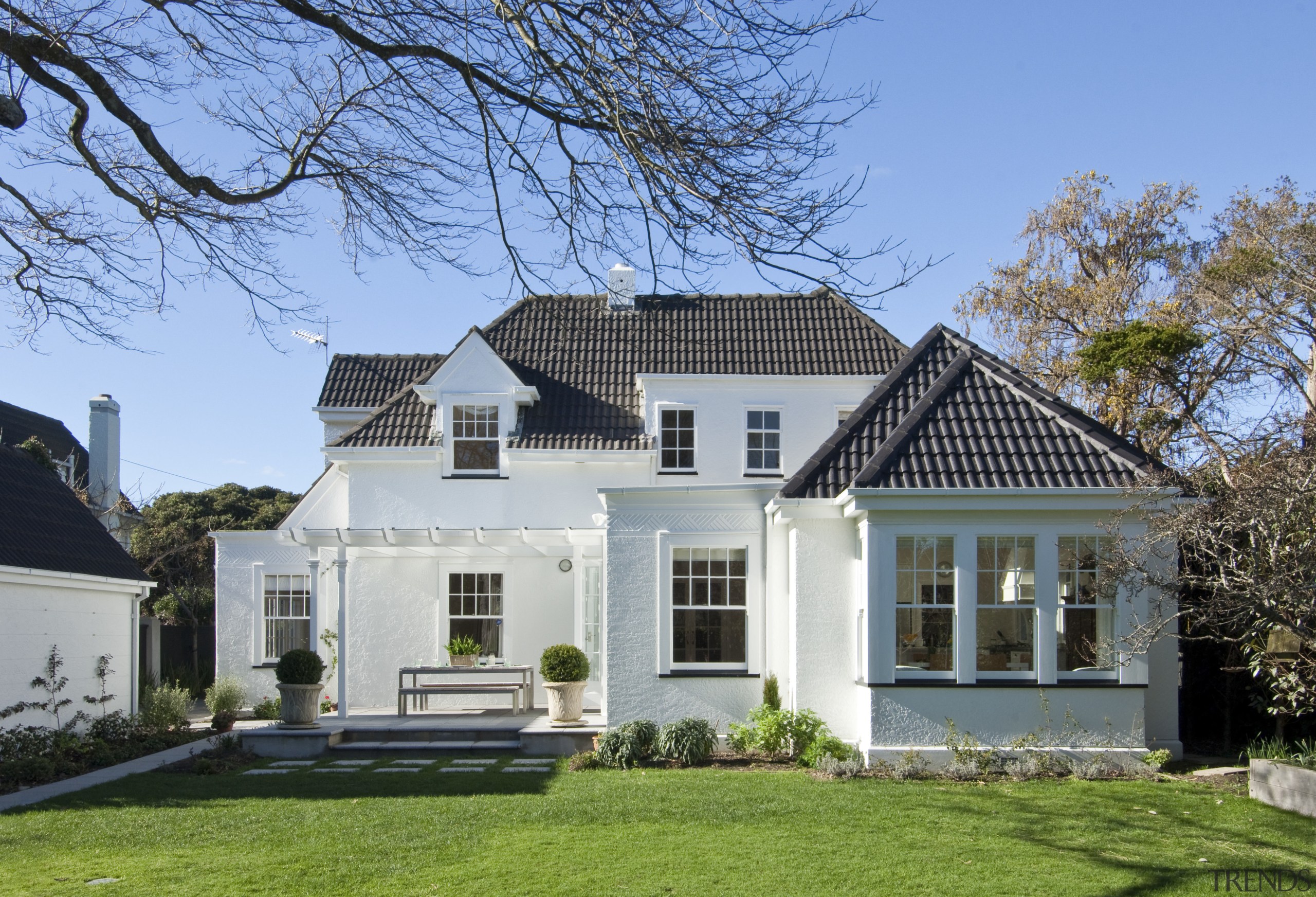 View of the extension to this 1930s home building, cottage, elevation, estate, facade, farmhouse, historic house, home, house, mansion, property, real estate, residential area, roof, siding, villa, window, teal, gray