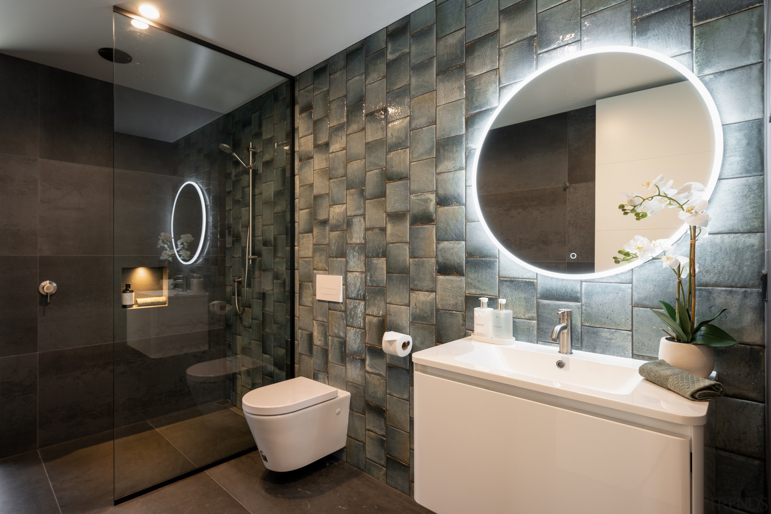 Downstairs ensuite with feature tilework and shower stall. 