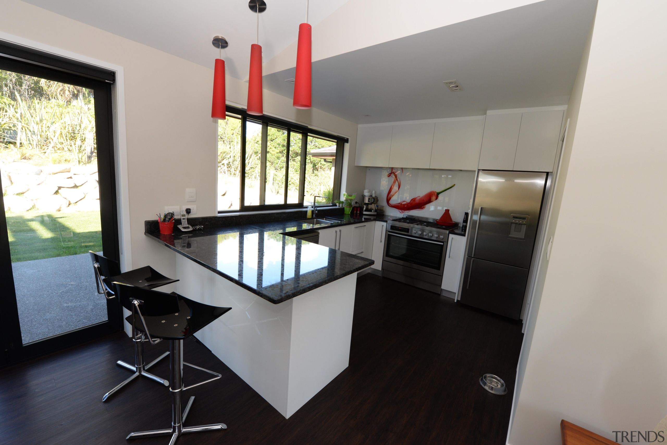 Kitchen design features red hot chilli splash back. interior design, property, real estate, room, gray, black