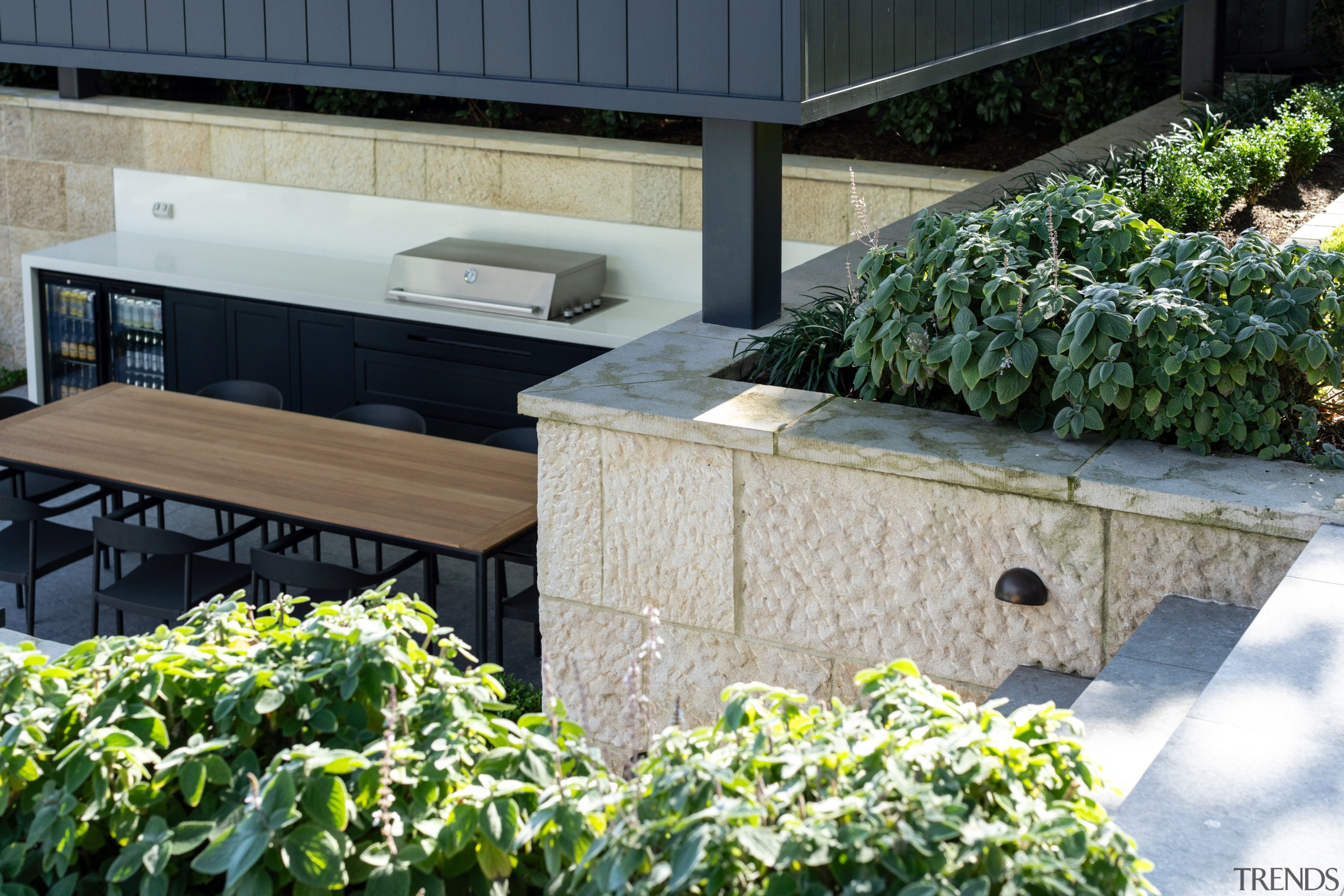 Pockets of plants add softness and blend the 