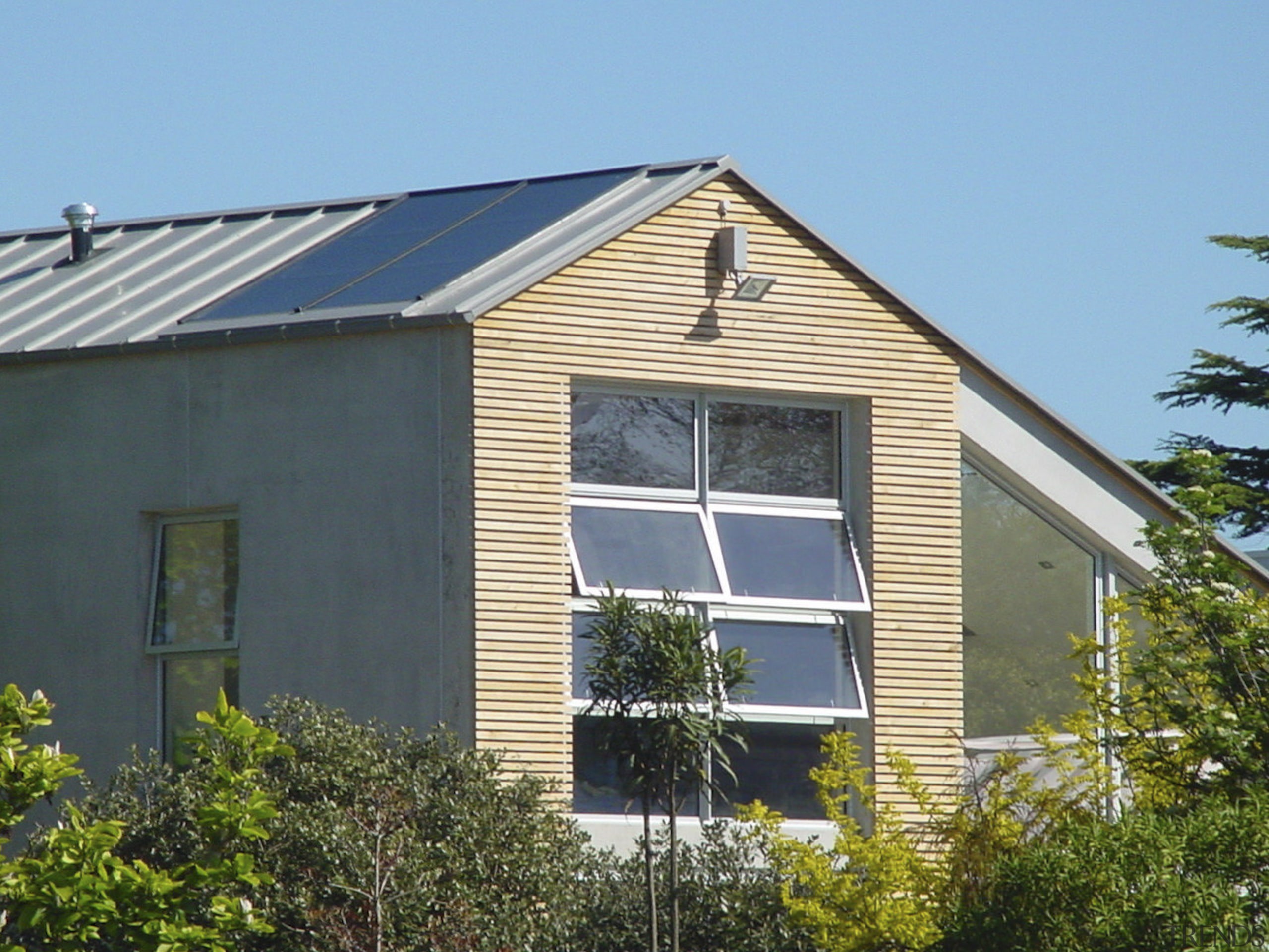 This large home efficiently uses solar energy thanks barn, building, cottage, facade, farmhouse, home, house, property, real estate, roof, shed, siding, window, teal