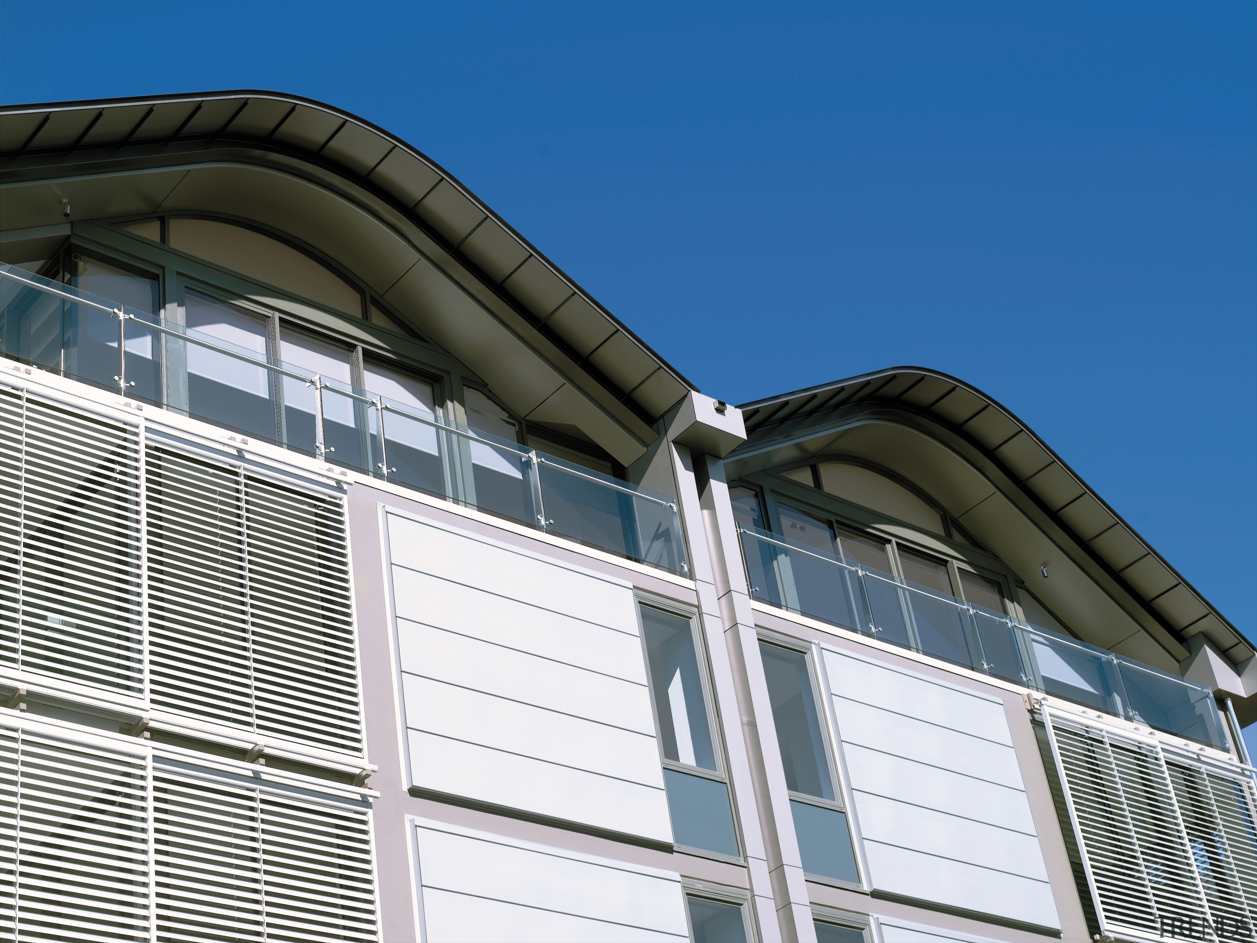 view of the saunders wharf apartments featuring crips architecture, building, commercial building, corporate headquarters, daylighting, daytime, facade, house, line, metropolitan area, residential area, roof, siding, sky, structure, window, blue, white