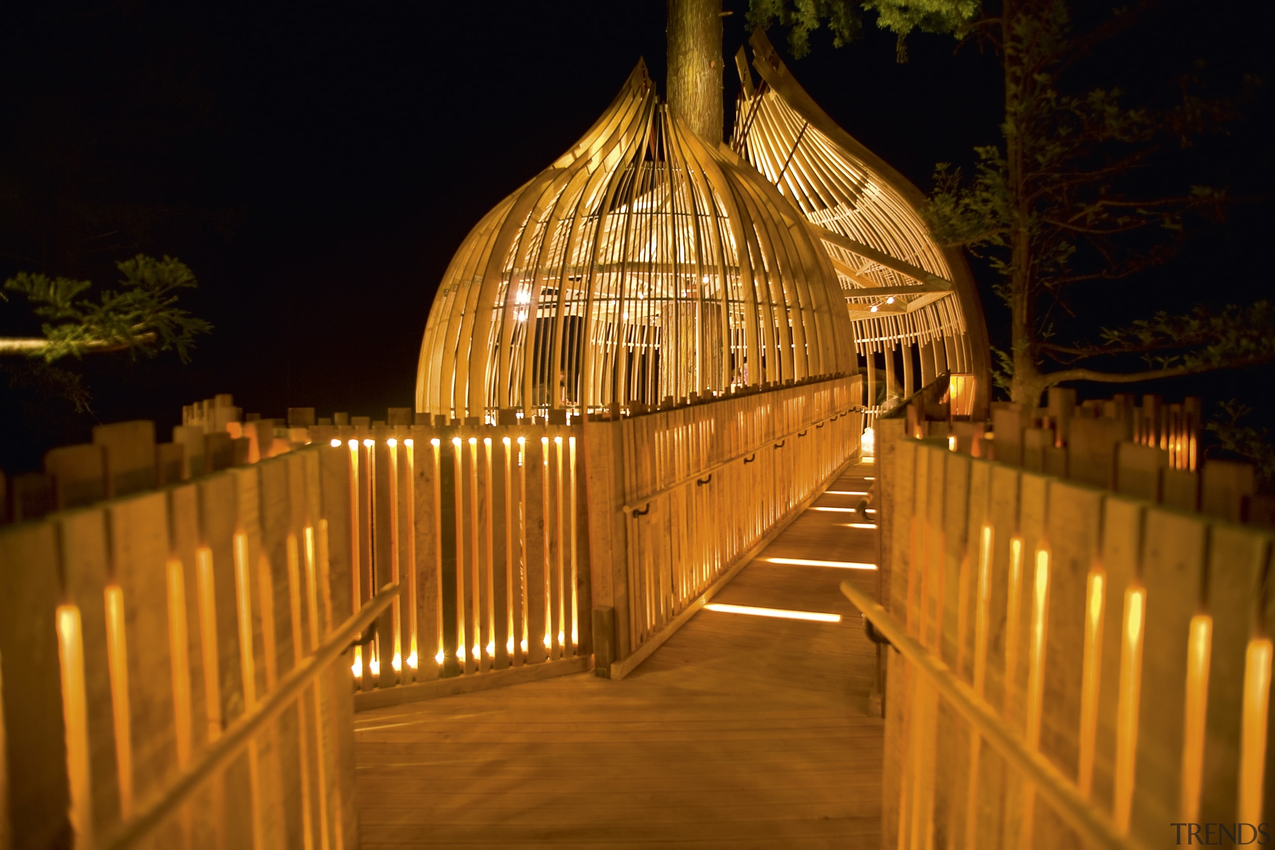 Image of the Yellow Treehouse restaurant which has architecture, landscape lighting, light, lighting, night, reflection, wood, brown, black