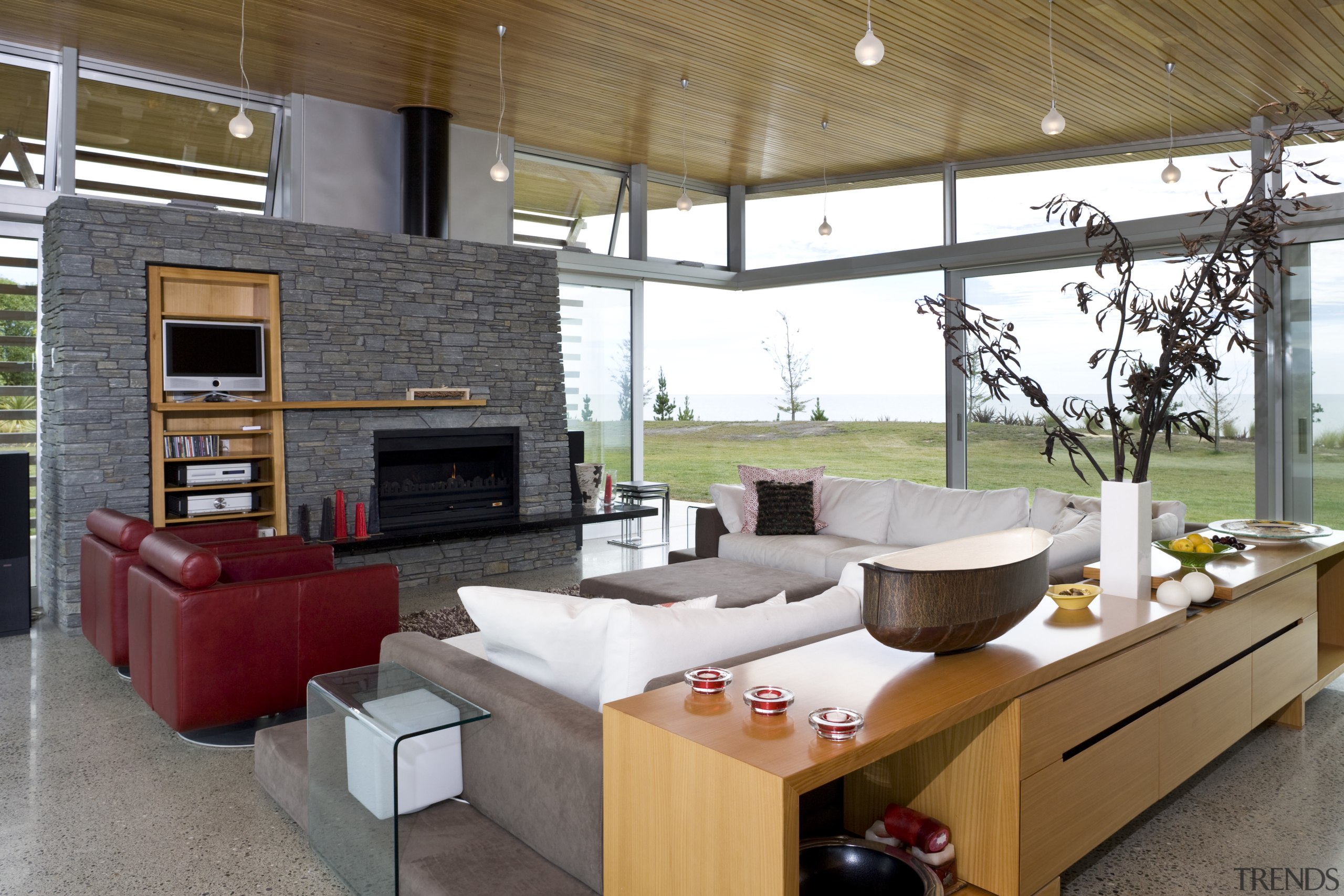 View of lounge, red couches, fireplace, schist wall, house, interior design, living room, gray