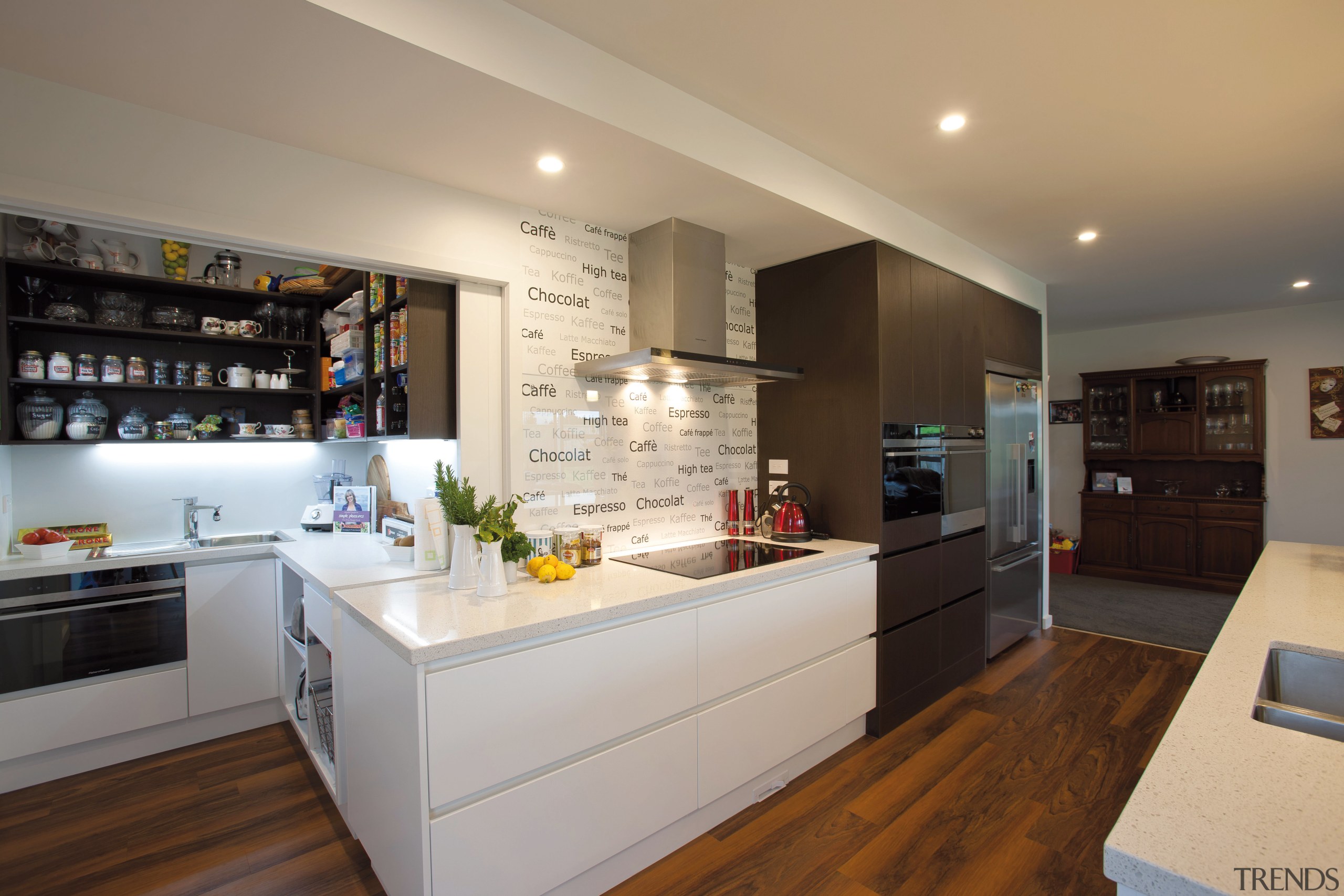 A large cavity door opens up a scullery countertop, interior design, kitchen, real estate, room, gray, brown