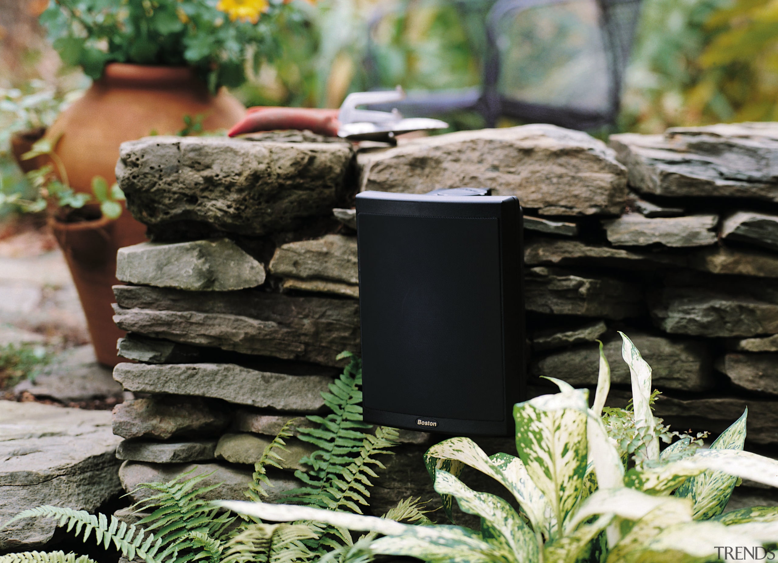 view of the outdoor voyager series speakers by grass, black