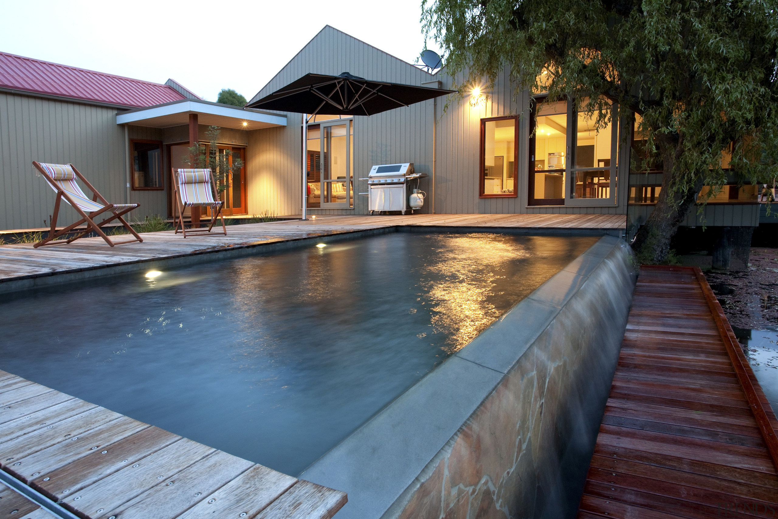View of contemporary pool and patio area. - backyard, estate, home, house, leisure, lighting, property, real estate, reflection, resort, swimming pool, villa, water