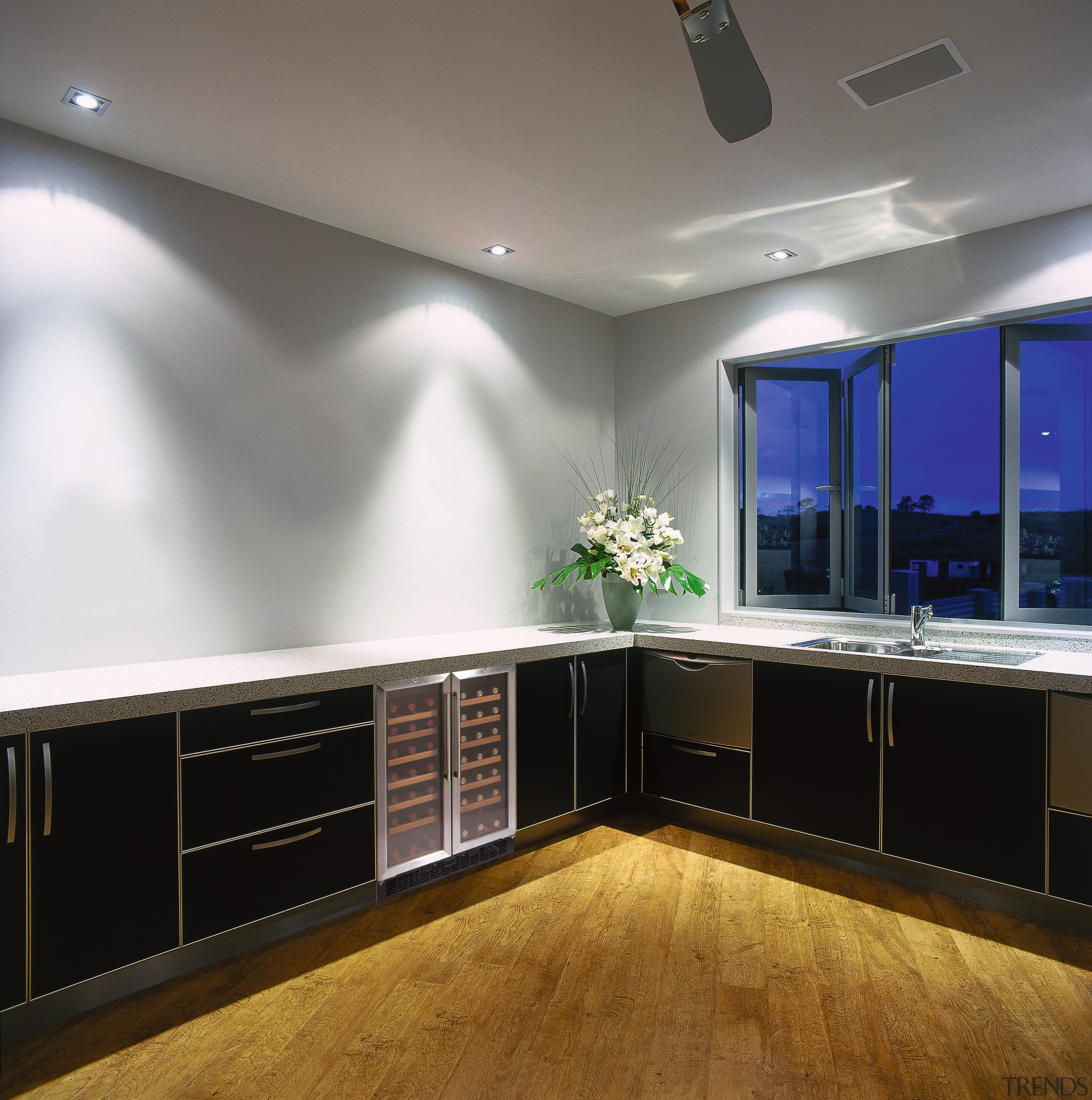 Kitchen with dark cabinetry and white benchtop, with cabinetry, ceiling, countertop, floor, flooring, interior design, kitchen, lighting, room, gray