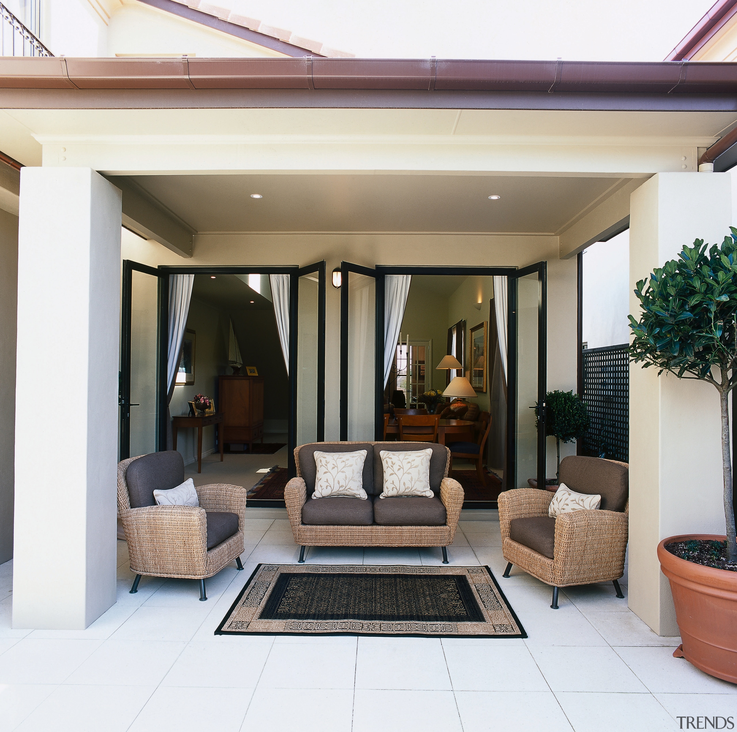 view of the outdoor living area featuring tiled door, estate, floor, home, house, interior design, living room, patio, property, real estate, window, white