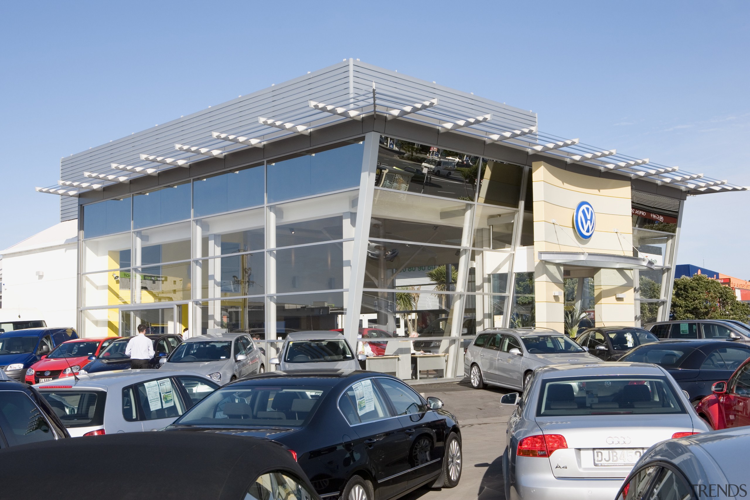 View of Tristram European's new VW showroom which building, car, car dealership, commercial building, corporate headquarters, family car, luxury vehicle, mixed use, motor vehicle, vehicle, teal