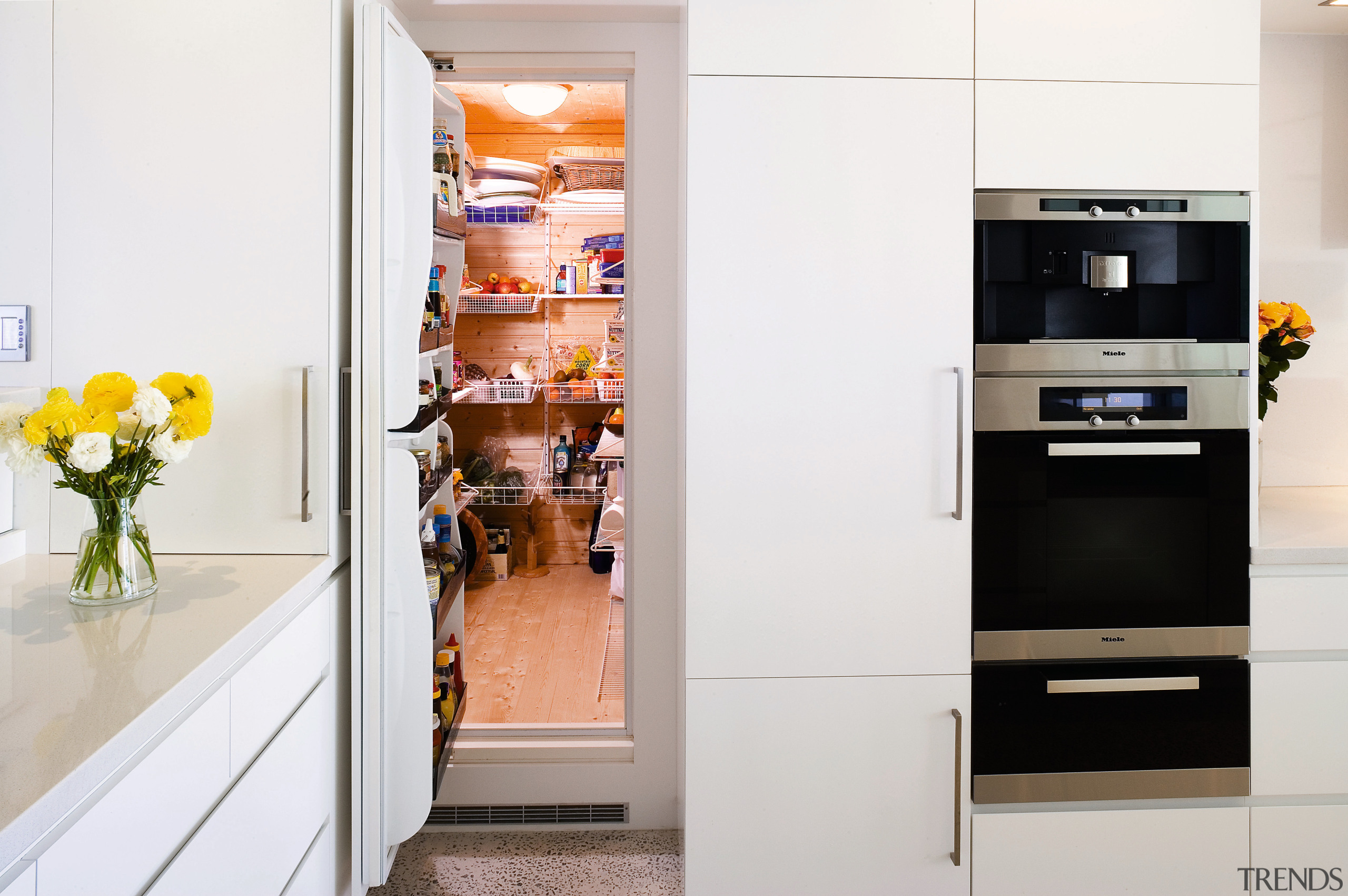 View of this kitchen featuring polished concrete flooring, countertop, home appliance, interior design, kitchen, kitchen appliance, major appliance, refrigerator, white