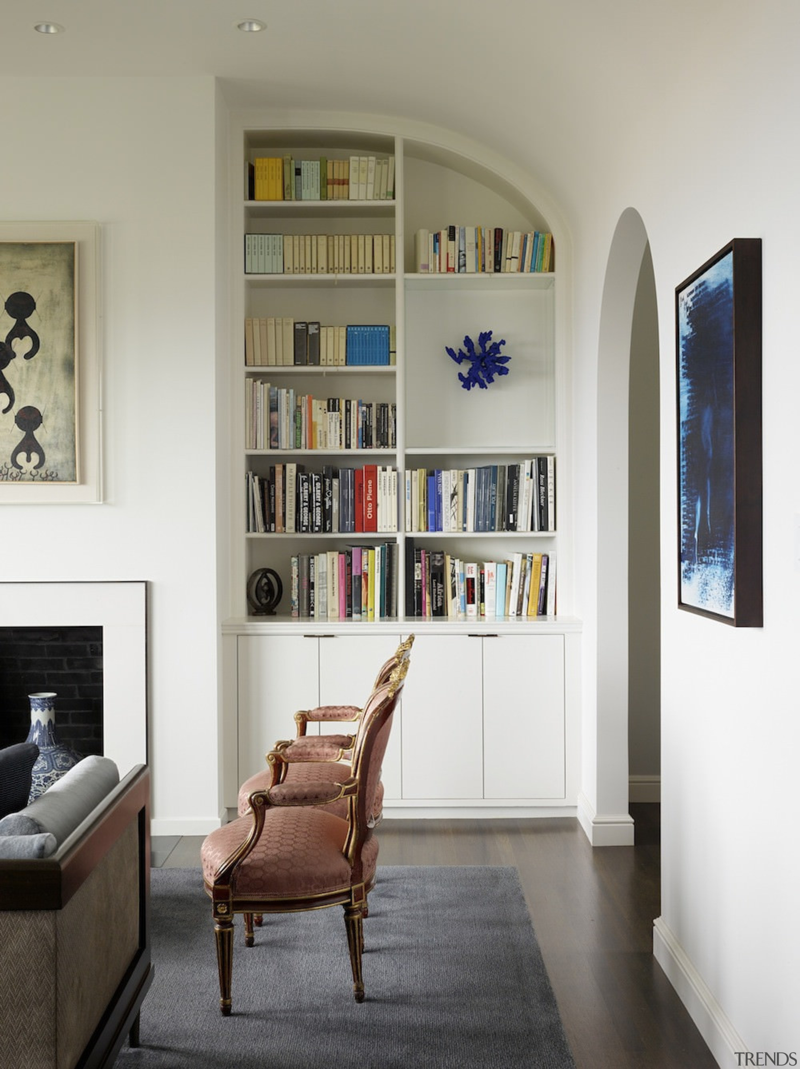 The bookshelf here follows the curvature of the bookcase, ceiling, floor, furniture, home, interior design, living room, room, shelf, shelving, wall, window, white, gray