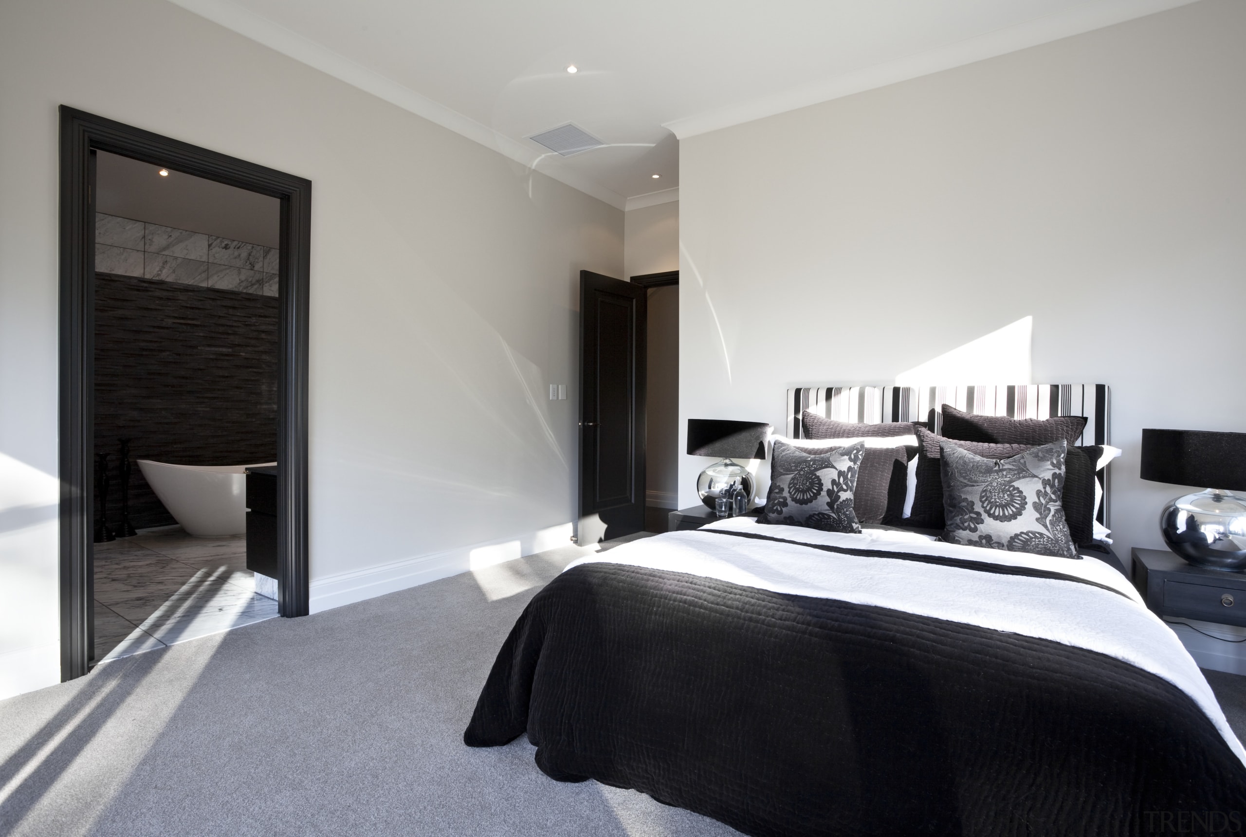 View of bedroom and bathroom with grey, black architecture, bed frame, bedroom, floor, home, interior design, property, real estate, room, suite, wall, window, gray, black