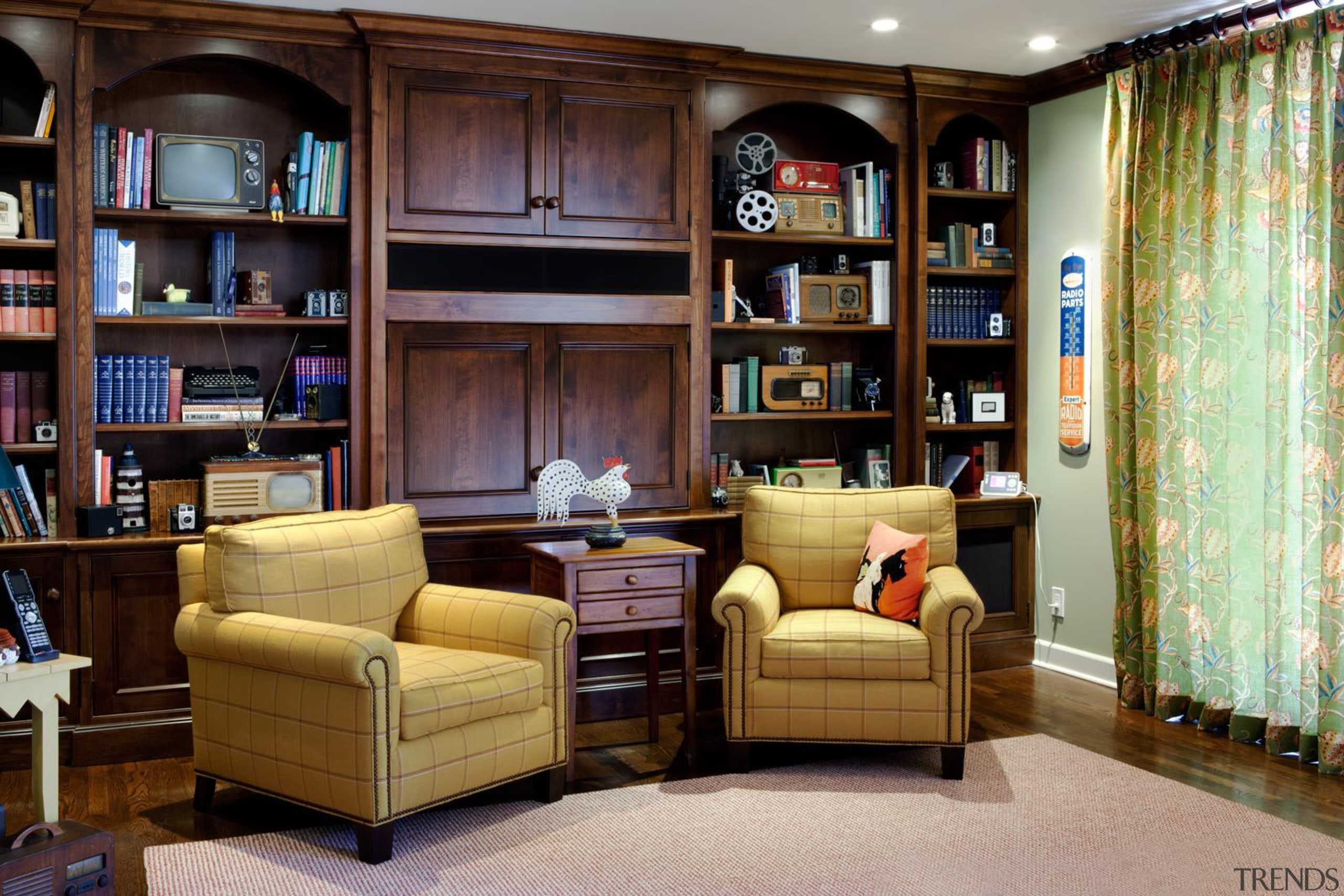 This room is where much of the client's bookcase, cabinetry, furniture, home, interior design, library, living room, room, shelf, shelving, black