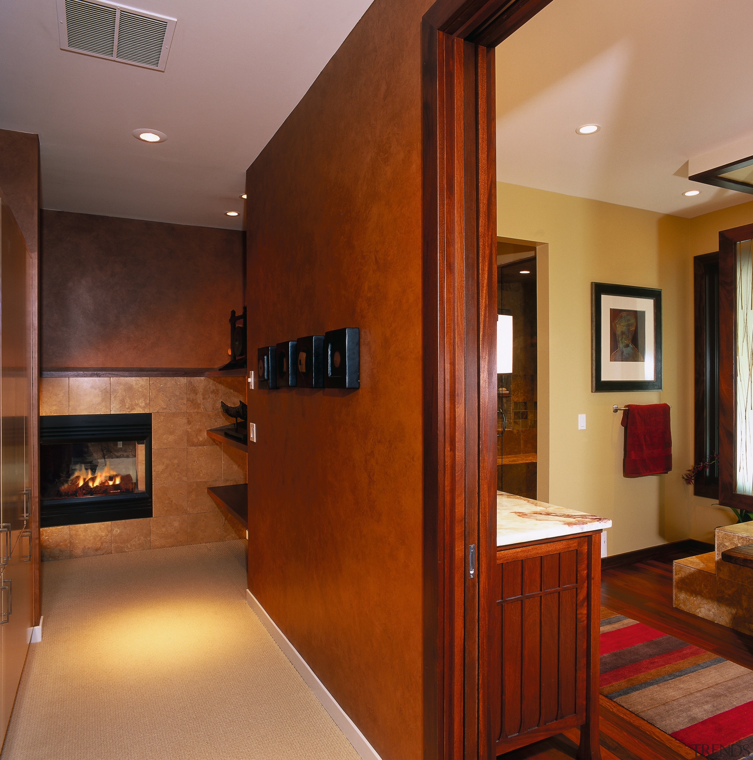 A view of a hallway, brown walls, cream architecture, cabinetry, ceiling, floor, flooring, hardwood, home, interior design, laminate flooring, living room, real estate, room, wall, wood, wood flooring, brown