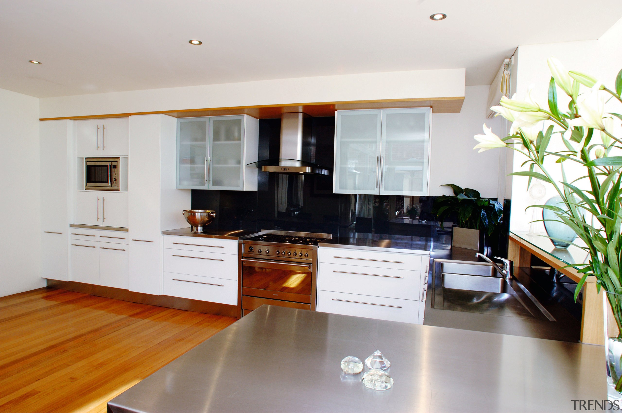 A view of a kitchen area, wooden flooring, cabinetry, countertop, cuisine classique, floor, flooring, hardwood, interior design, kitchen, living room, property, real estate, room, wood flooring, white