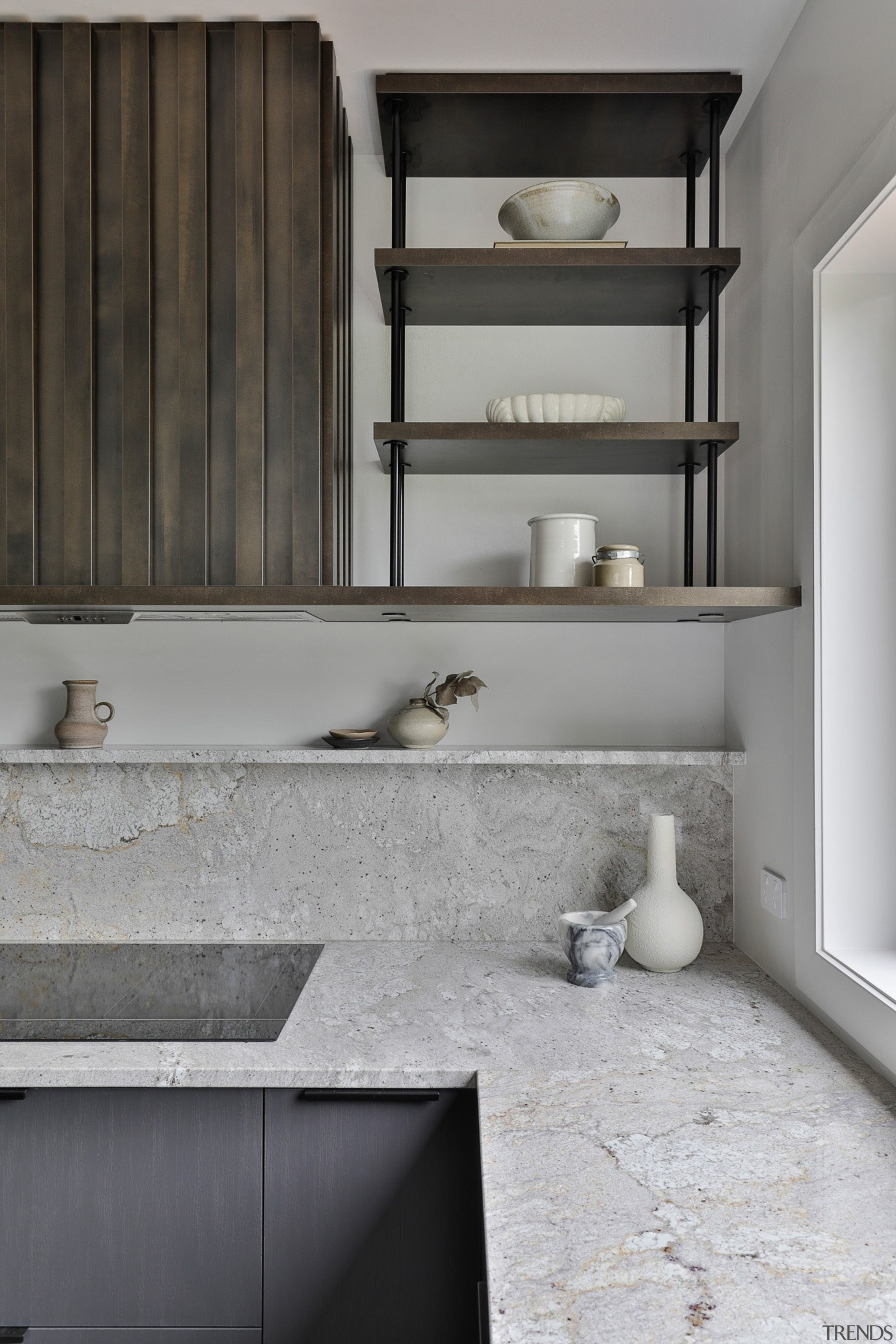 The powder-coated shelving and stone upstand situated above 