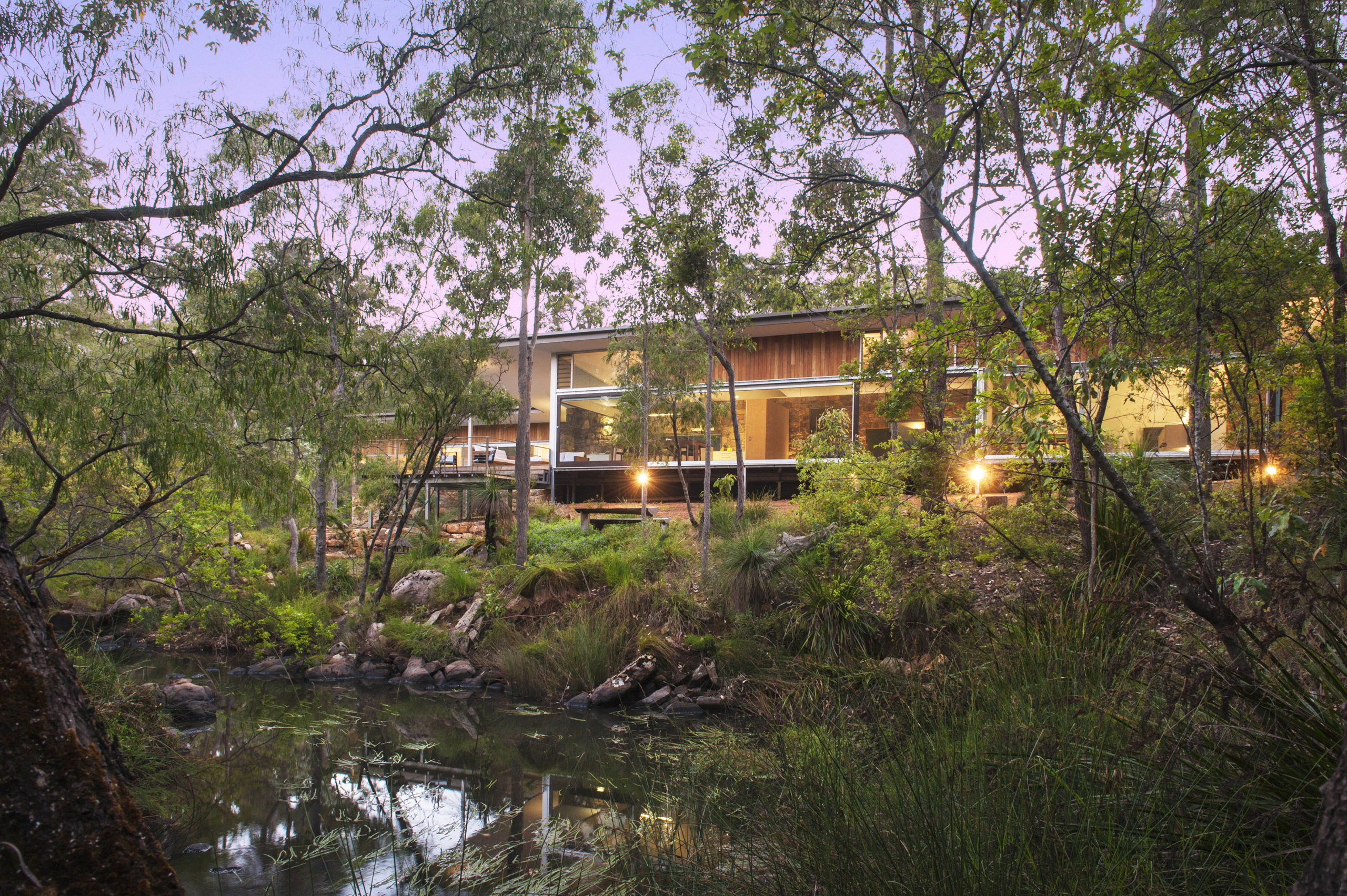 Much of this Margaret River property is covered bayou, cottage, estate, home, house, landscape, plant, pond, property, real estate, reflection, tree, water, brown