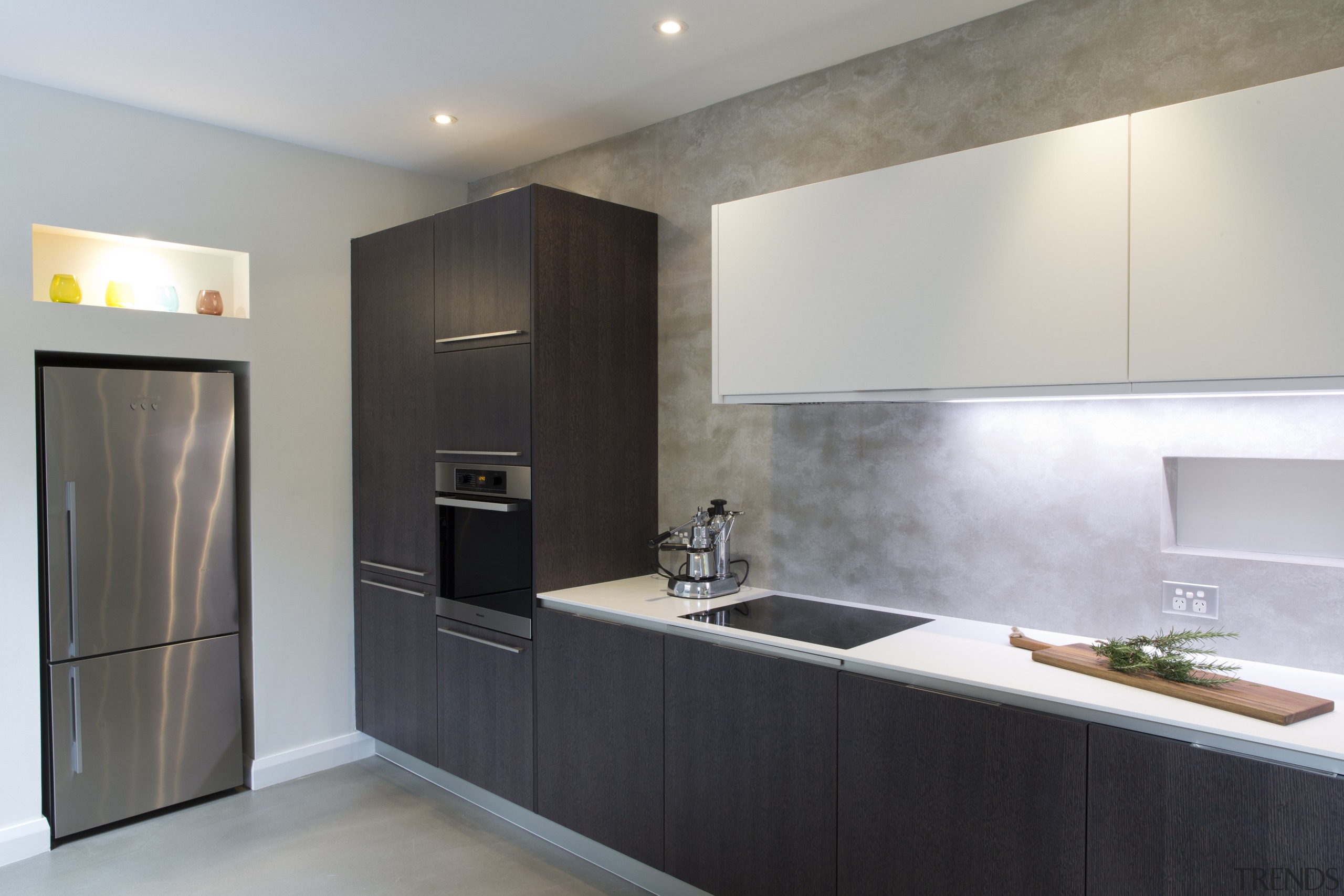 Geometric forms define this new kitchen designed by cabinetry, countertop, interior design, kitchen, real estate, room, gray, black