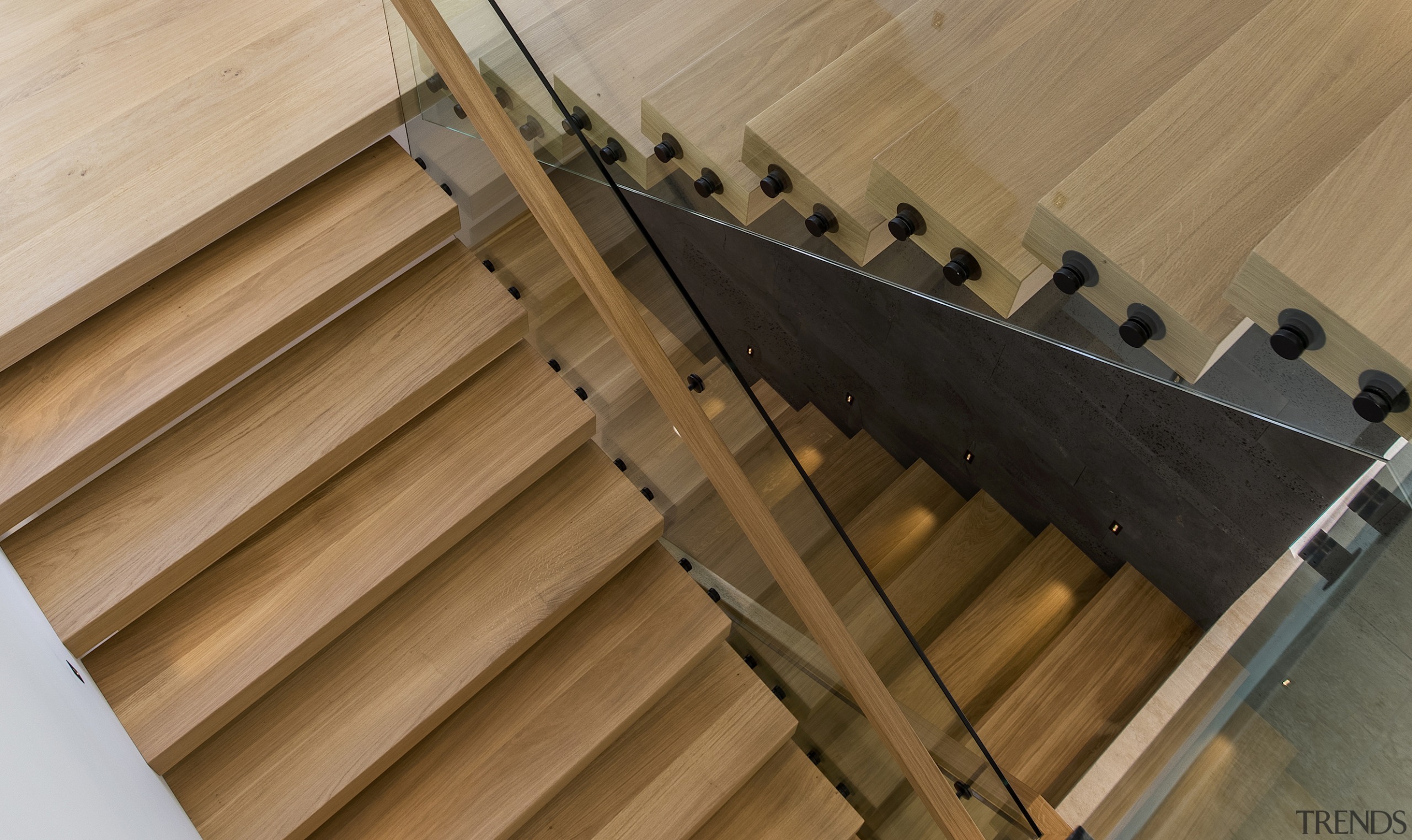 A timber tread stair and concrete walls make 