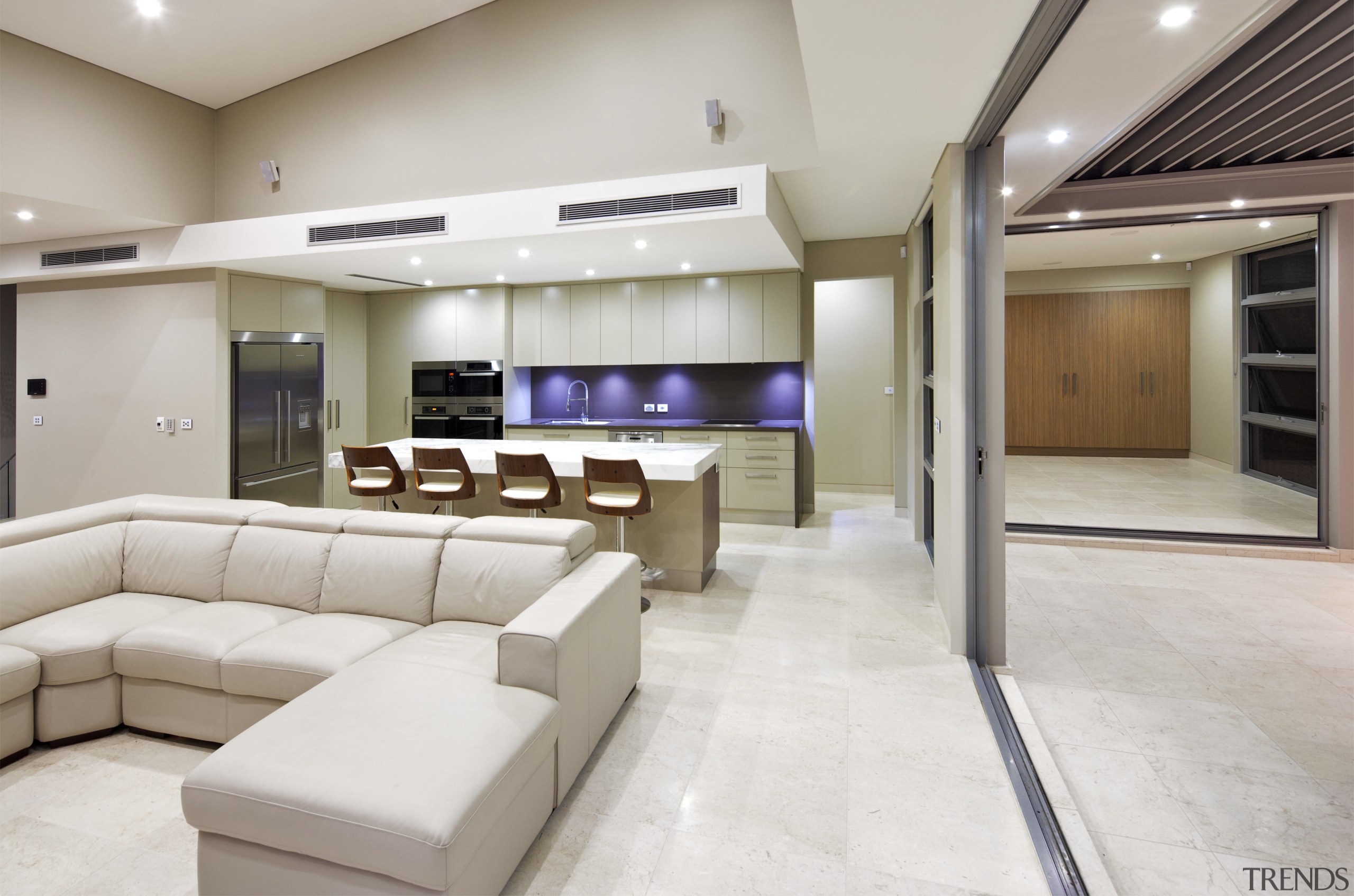 Lounge and kitchen area with cream couches and ceiling, floor, flooring, interior design, lobby, real estate, gray