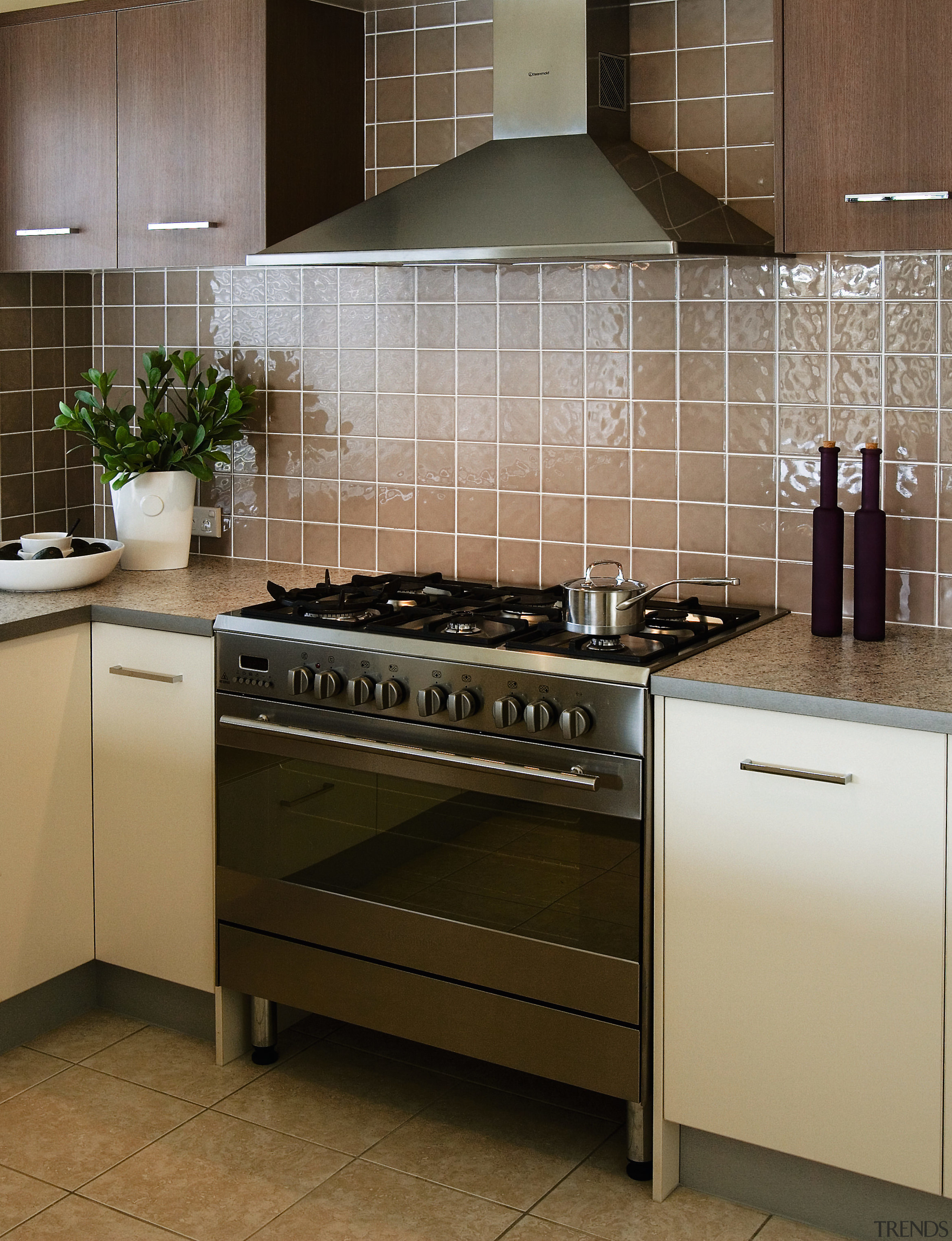 View of kitchen showing stainless steel freestanding oven cabinetry, countertop, cuisine classique, floor, flooring, gas stove, home appliance, kitchen, kitchen appliance, kitchen stove, major appliance, room, tile, brown