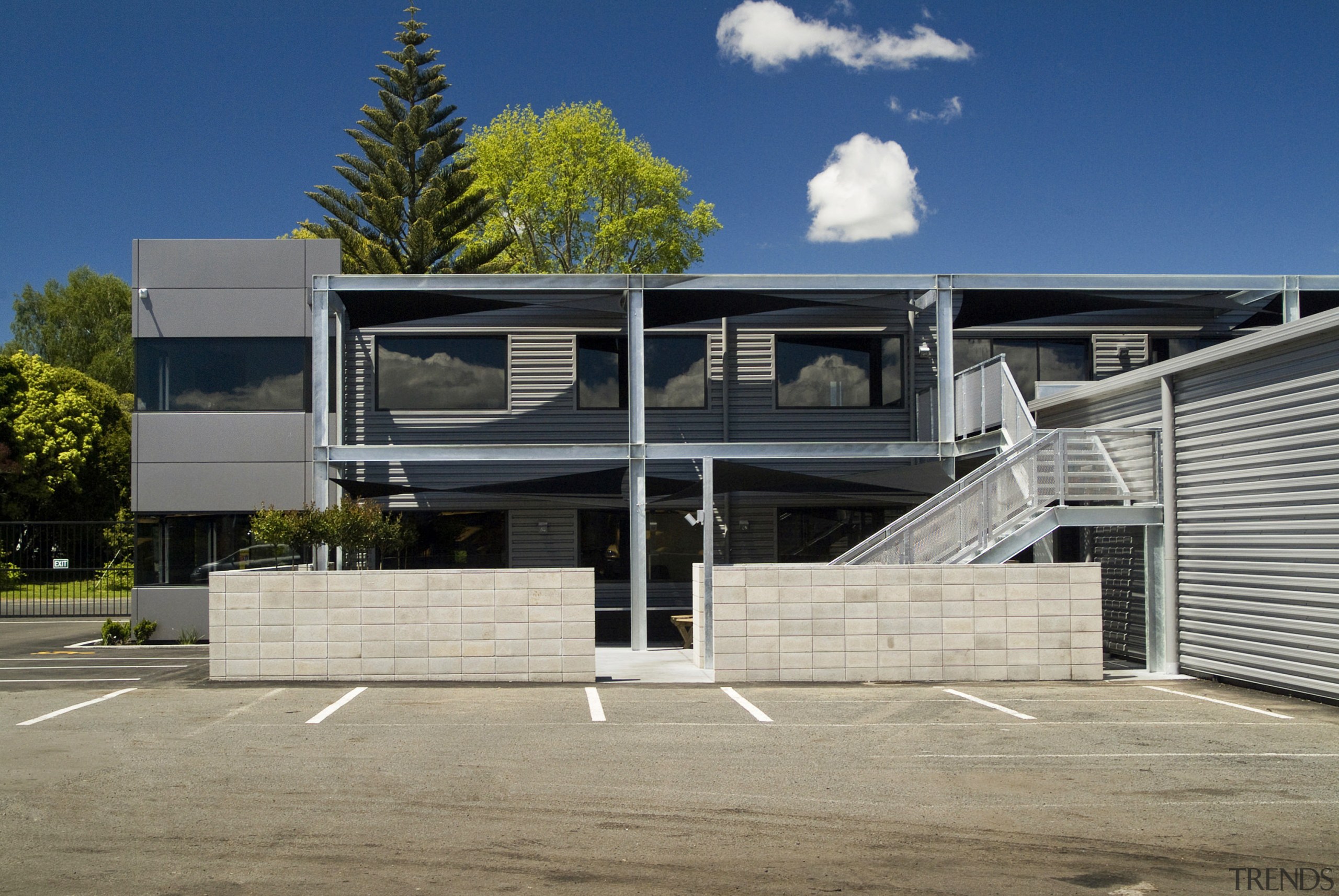 View of the courtyard and stairway beside the architecture, building, commercial building, corporate headquarters, elevation, facade, home, house, property, real estate, residential area, structure, gray