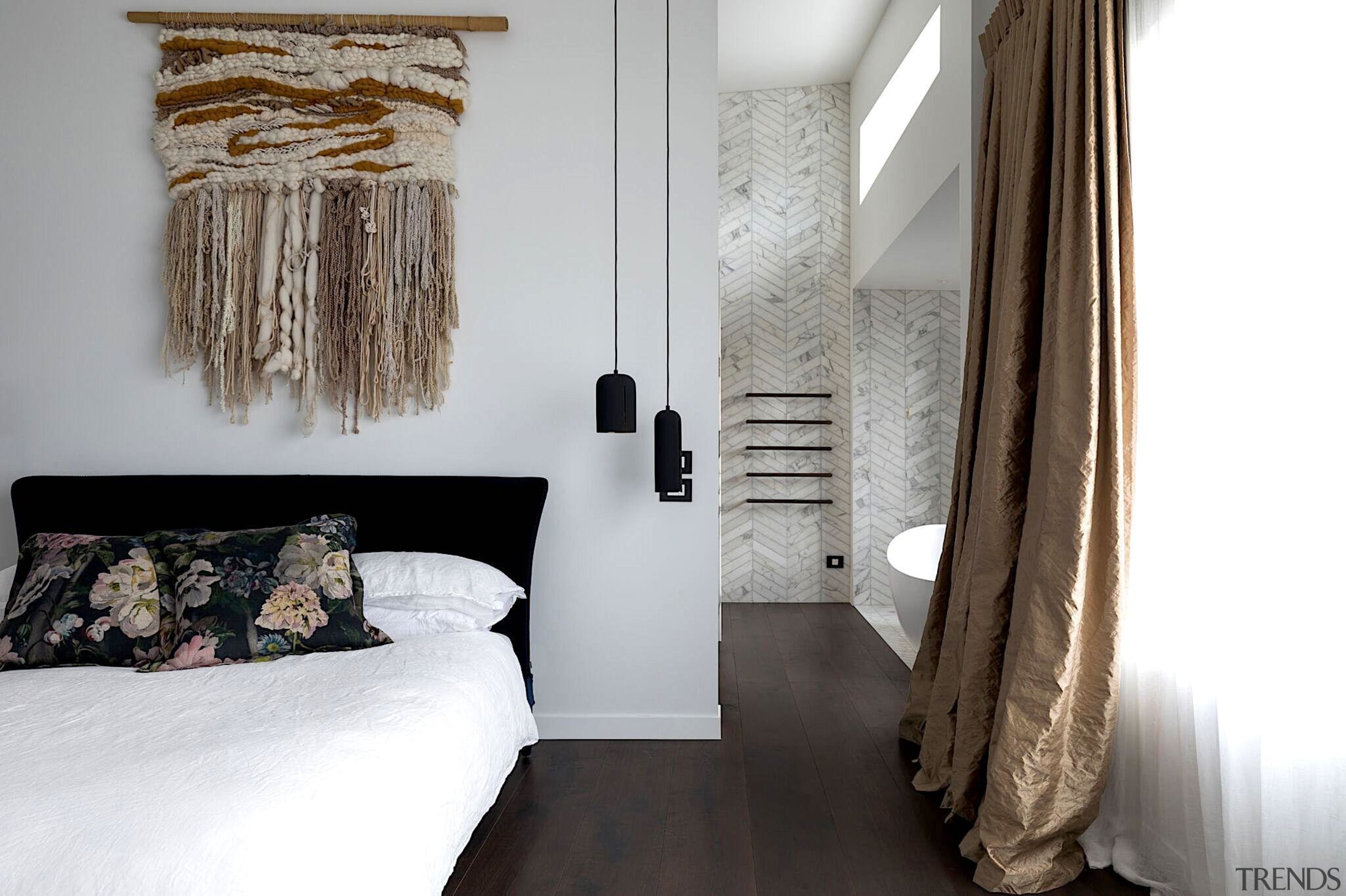 Rich timber floors run between bathroom and bedroom white, gray