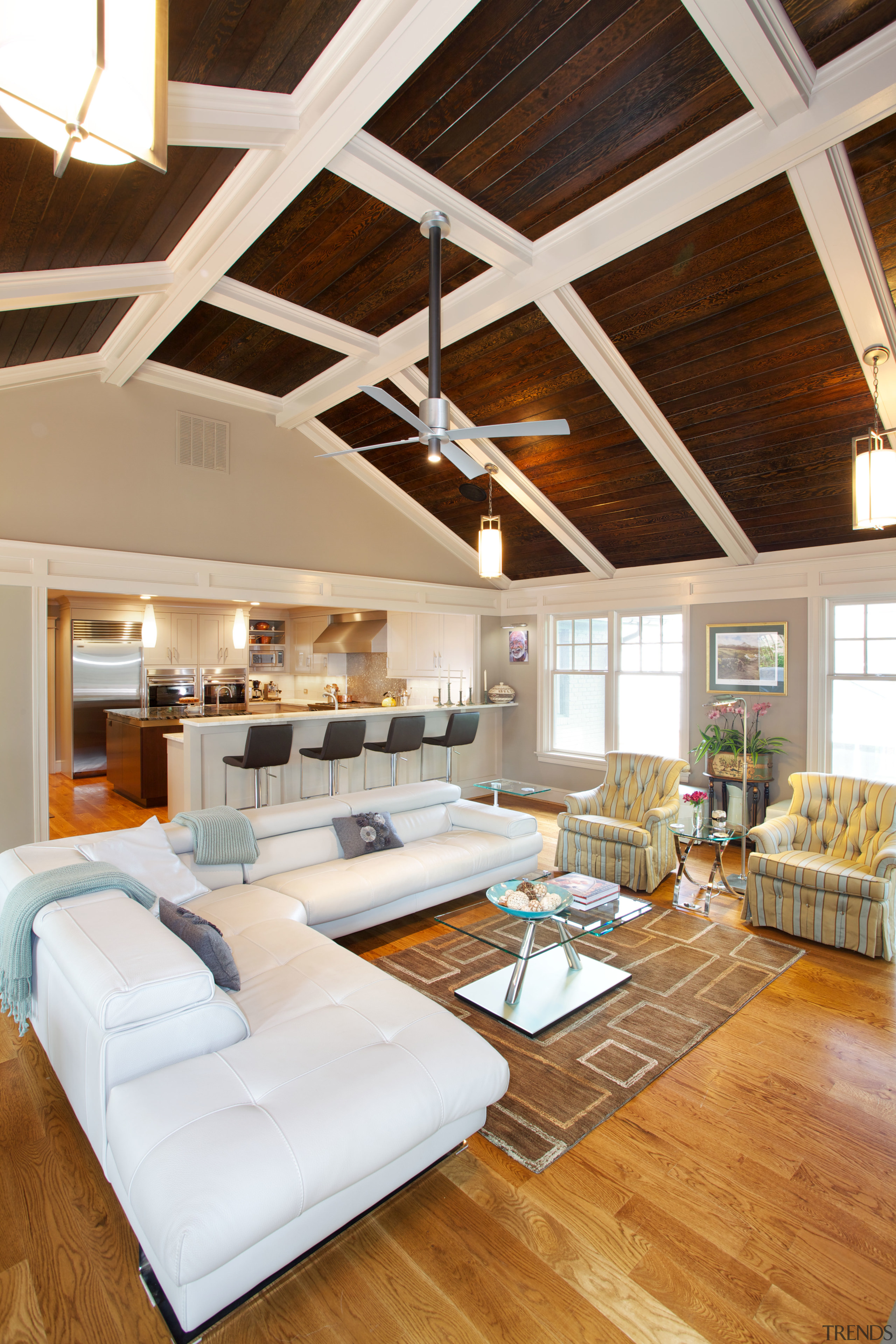 This open-plan family room and kitchen are part beam, ceiling, daylighting, floor, flooring, hardwood, home, interior design, living room, loft, real estate, room, wood, wood flooring, white, brown