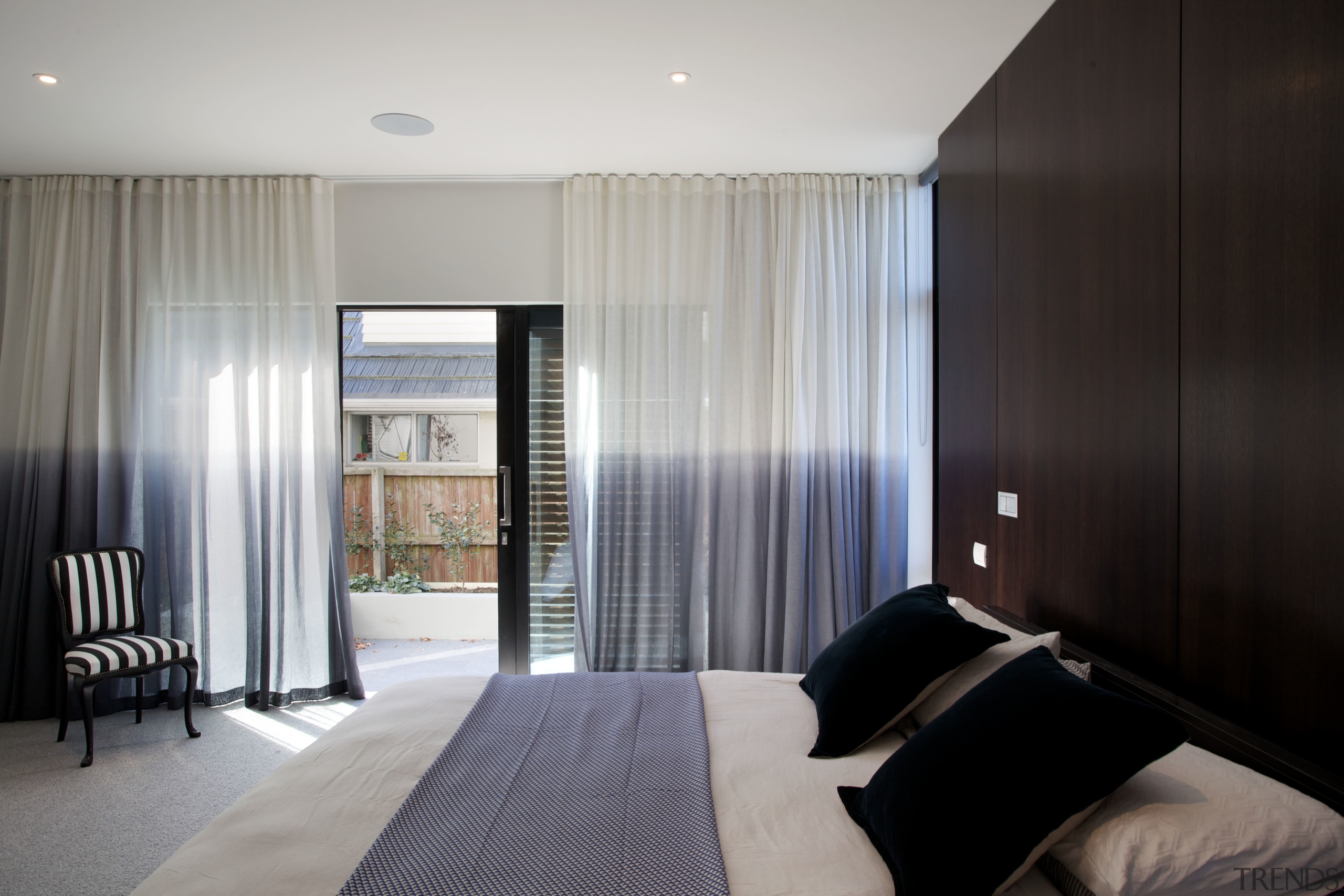 In this new home, the master suite opens bedroom, ceiling, curtain, interior design, property, real estate, room, suite, window, window covering, window treatment, gray, black