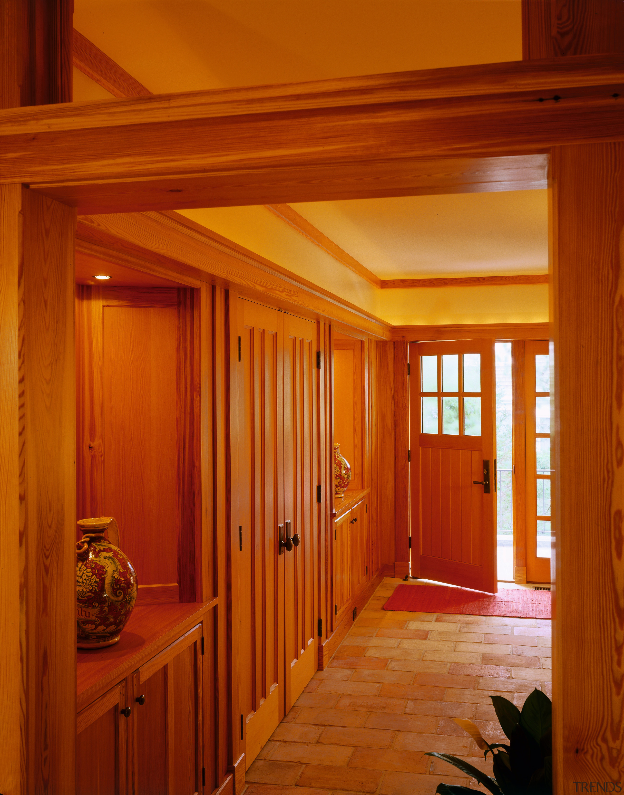 view of the entrance way featuring cobbled flooring, architecture, beam, ceiling, daylighting, door, floor, flooring, hardwood, home, house, interior design, lighting, real estate, room, wall, window, wood, wood stain, red, brown