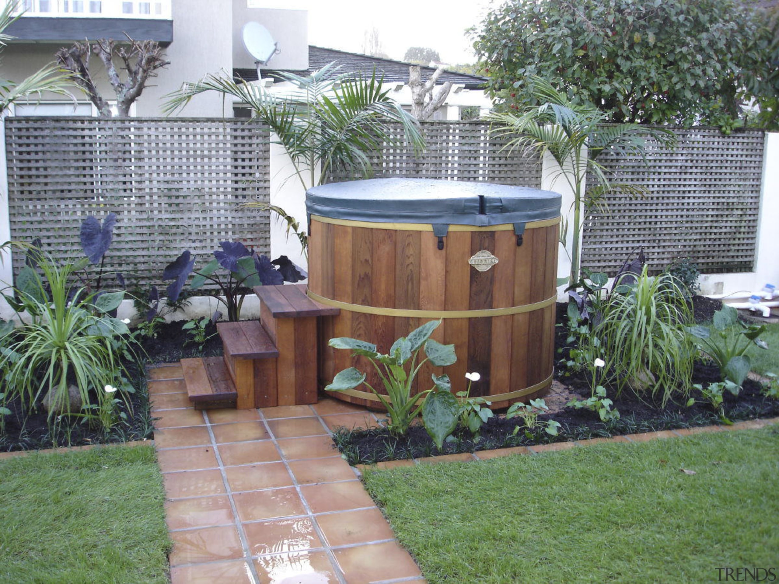 Exterior view of this hot tub &amp; surround backyard, garden, grass, landscaping, outdoor structure, plant, wood, yard, gray, green