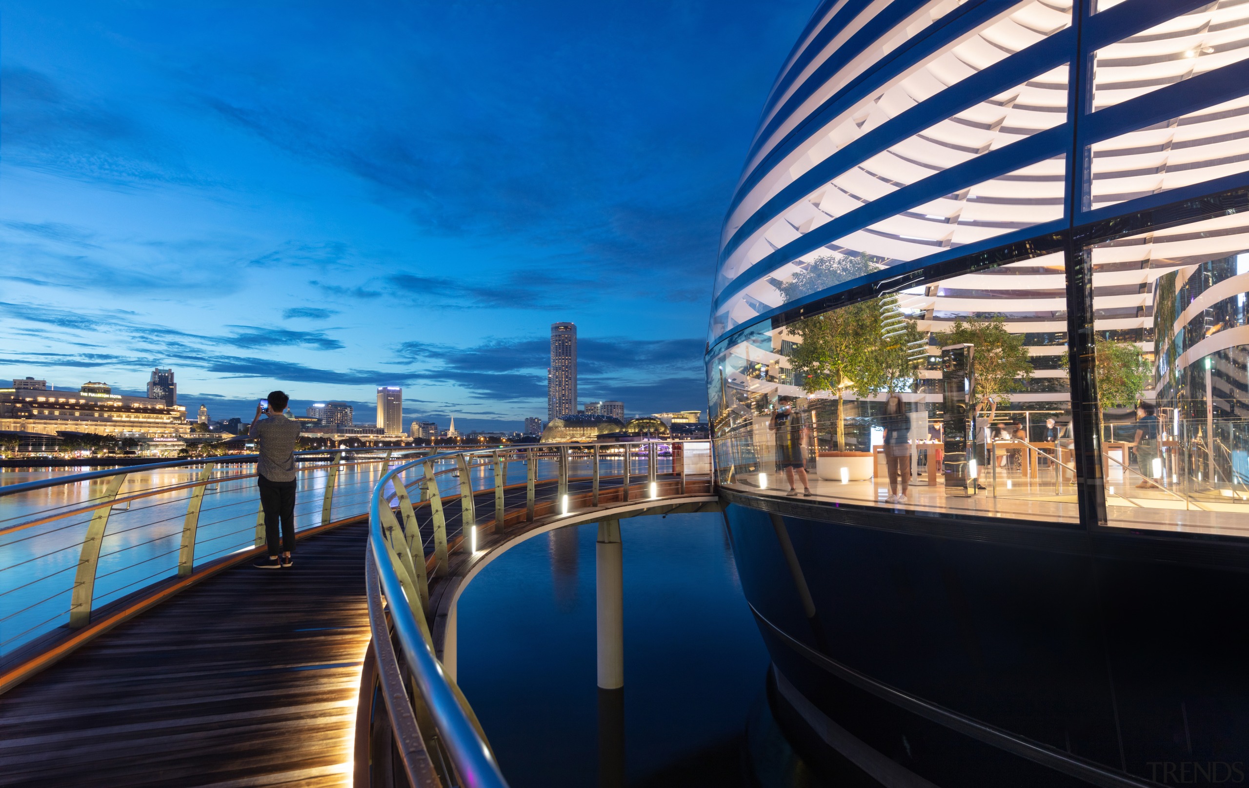 A lit walkway runs round the futuristic retail 